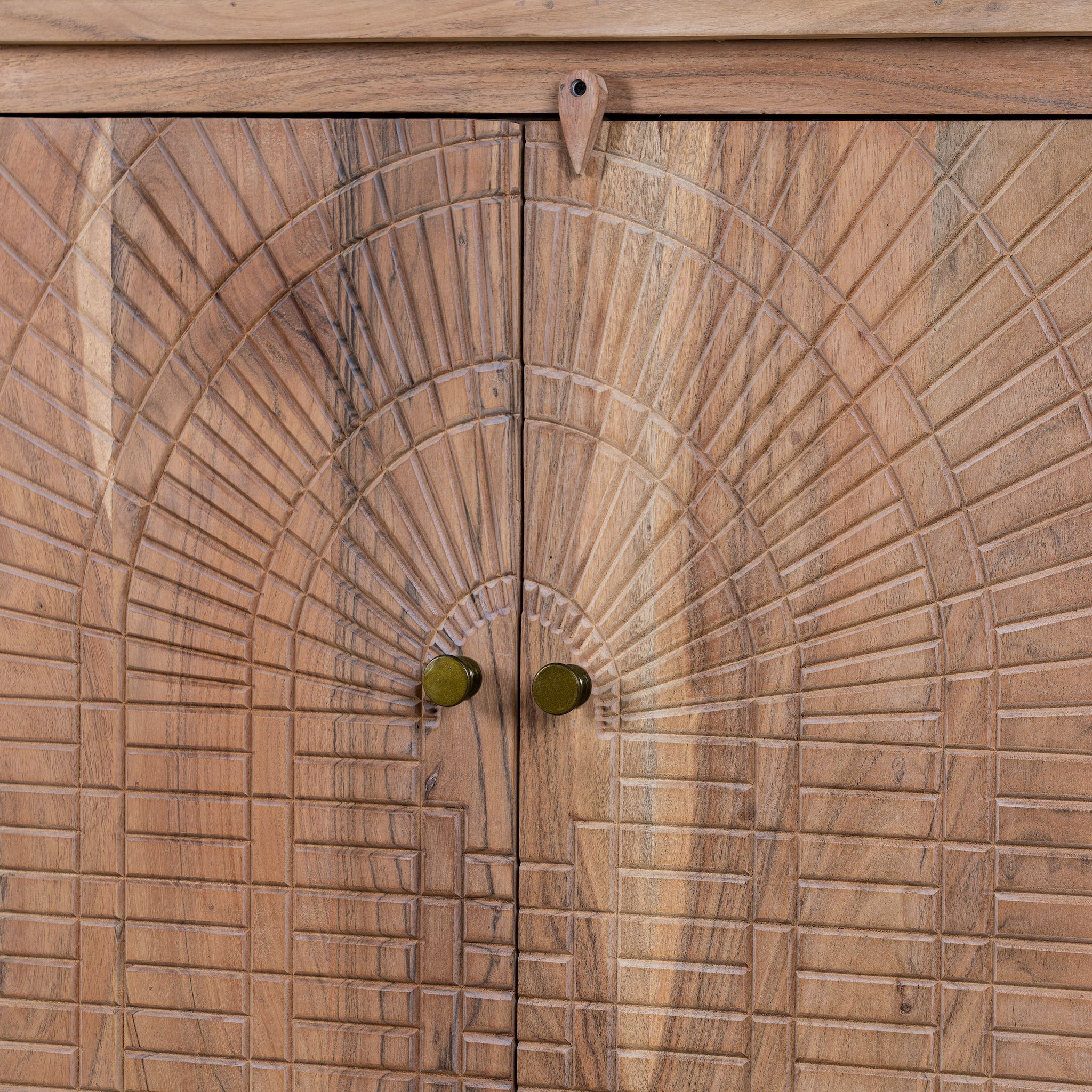Close up picture of a sideboard with artisanal inspired carvings on 4 doors made of acacia wood.