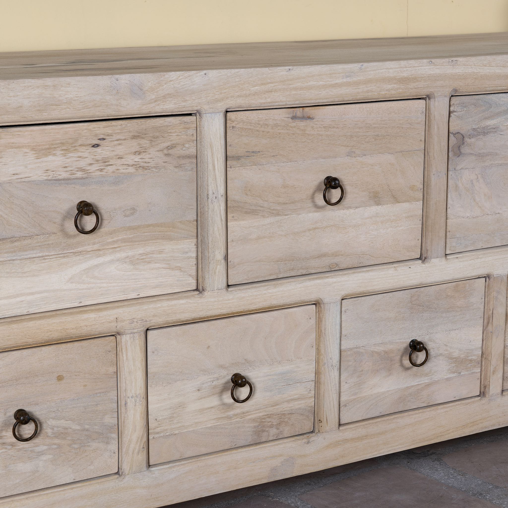 Close up image of a reclaimed wood furniture chest of drawers with 11 drawers, Ibiza style living room furniture with sandblasted finish, 250 × 40 × 85 cm.