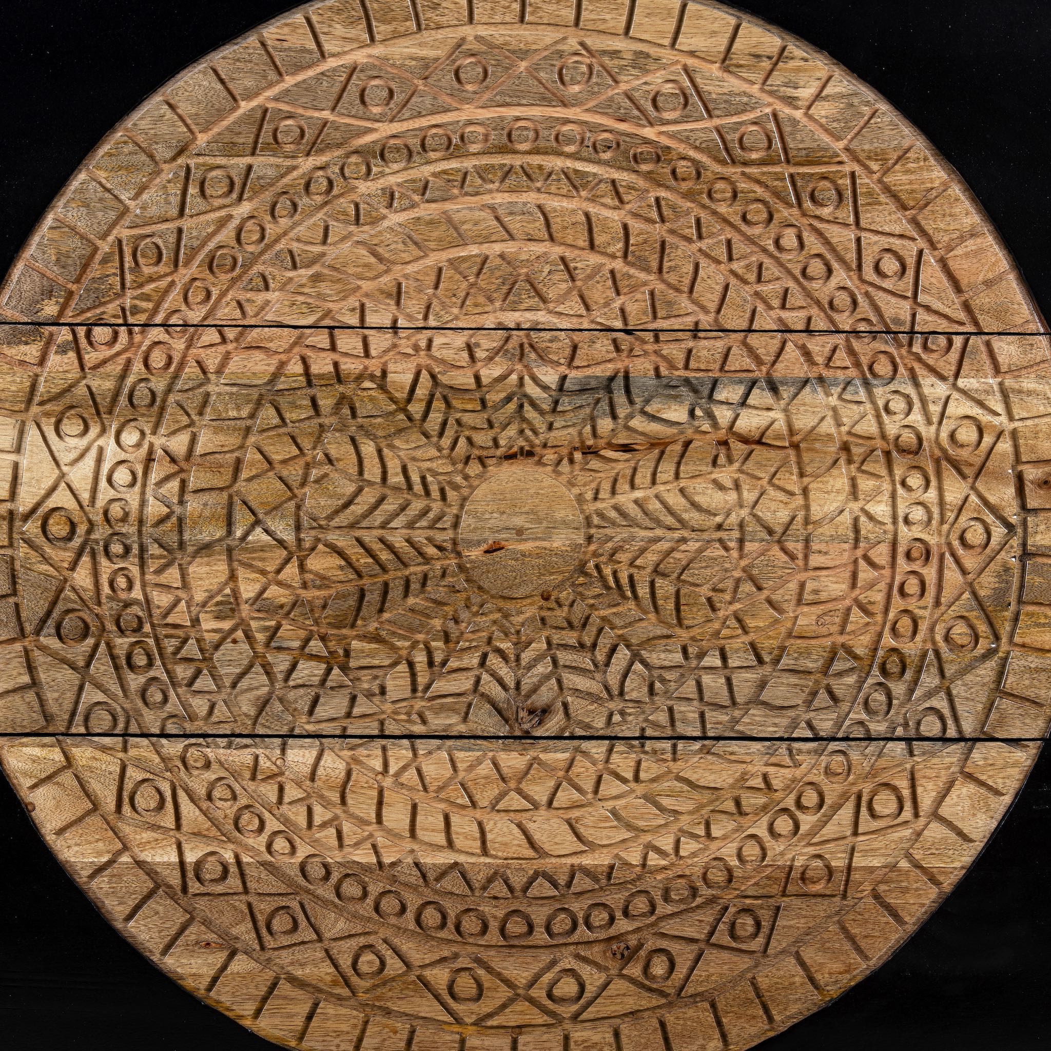 Mango wood drawer chest with black finish and large circular floral hand-carving on the front.