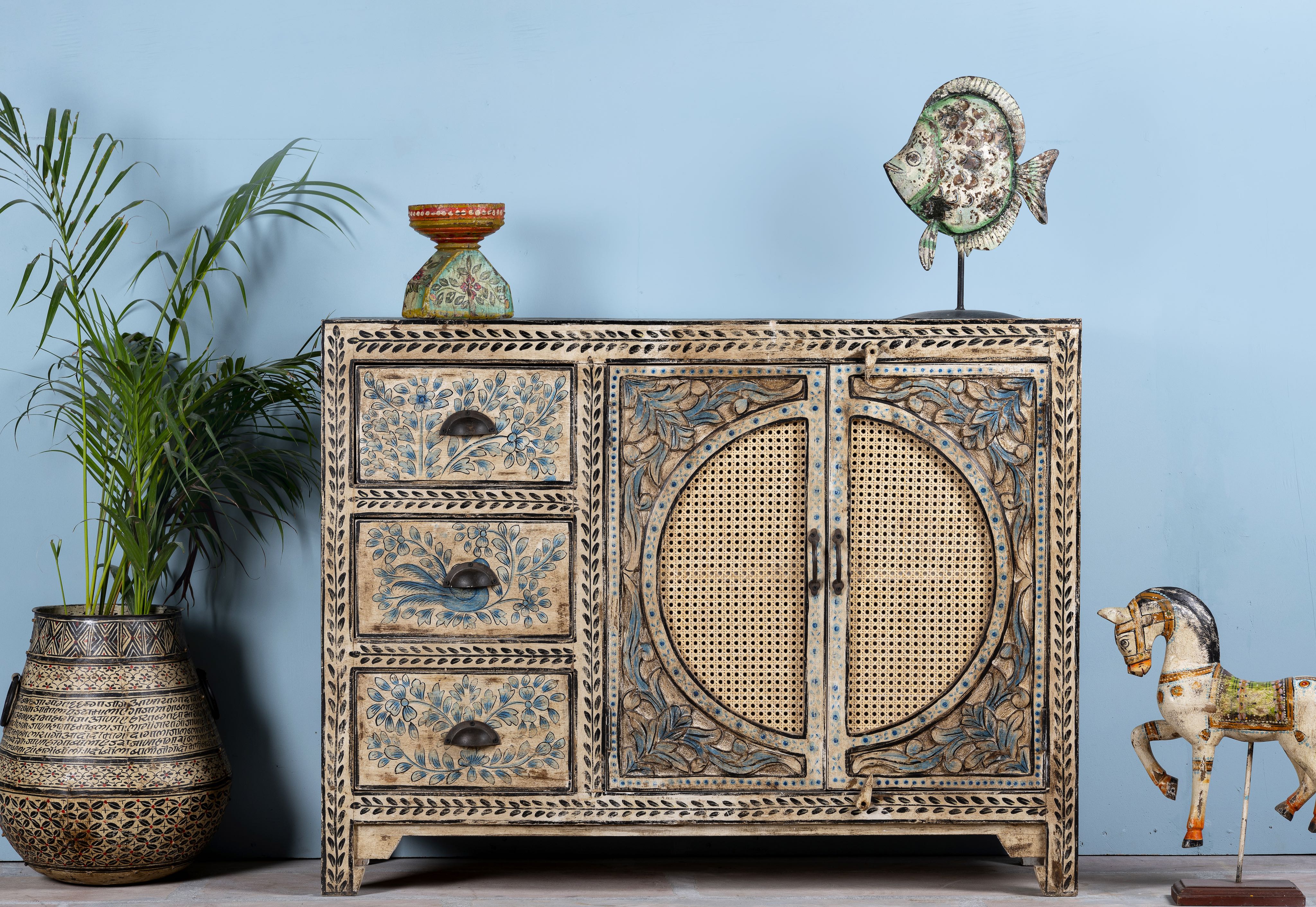Hand painted sideboard in blue and beige with rattan door inserts; unique furniture for boho style interiors, 120 × 40 × 92 cm.