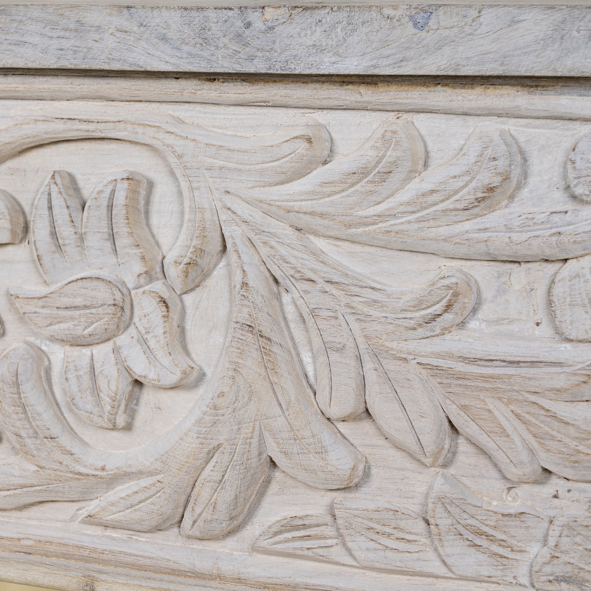 Close up image of a hand-carved whitewashed reclaimed wood console table with floral details; vintage home decor with rustic and bohemian charm, 196 × 44 × 80 cm.