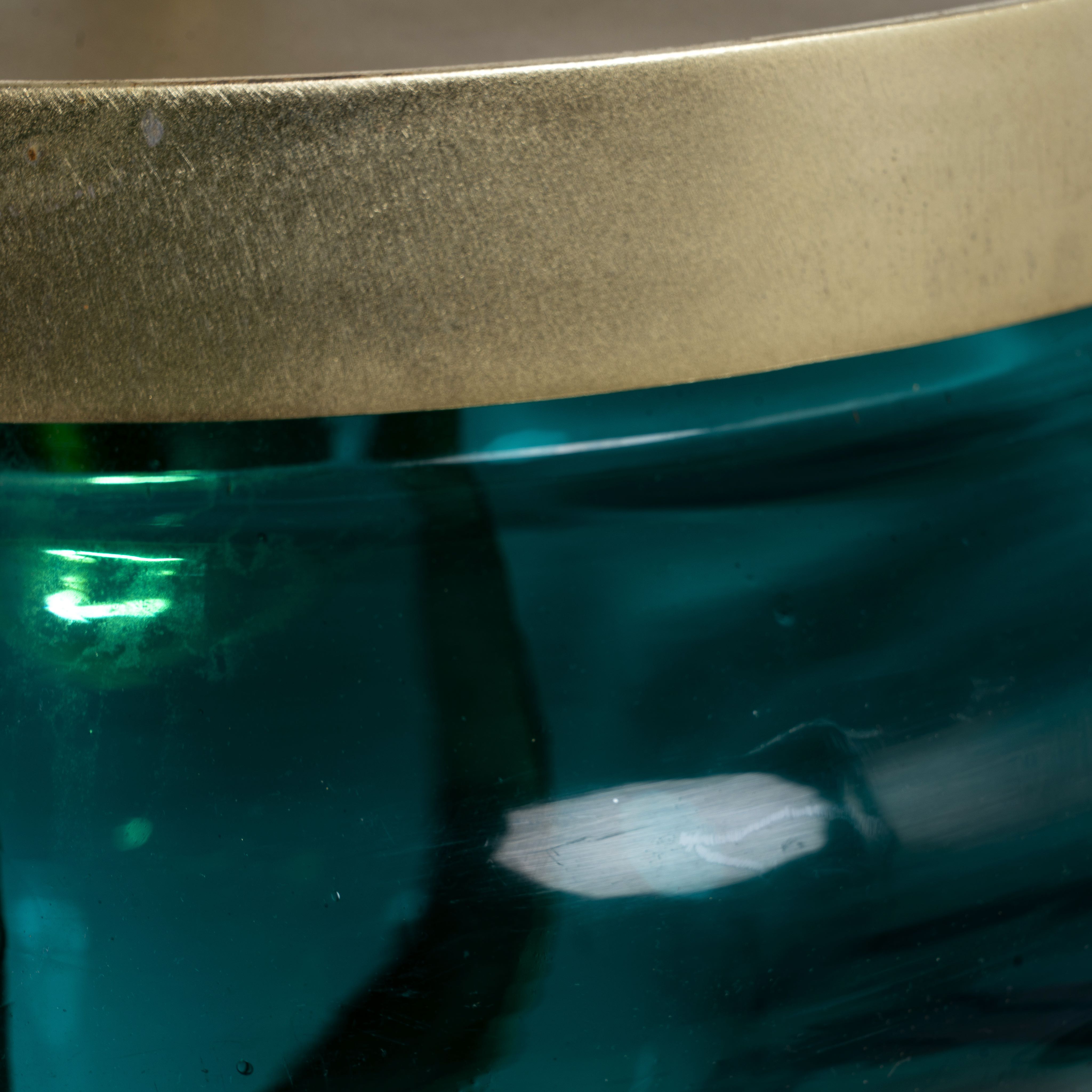 Close up image of a retro pendant lamp with large green glass shade and brass-plated iron frame – vibrant glass lamp ideal for dining rooms, living spaces, or bedrooms.
