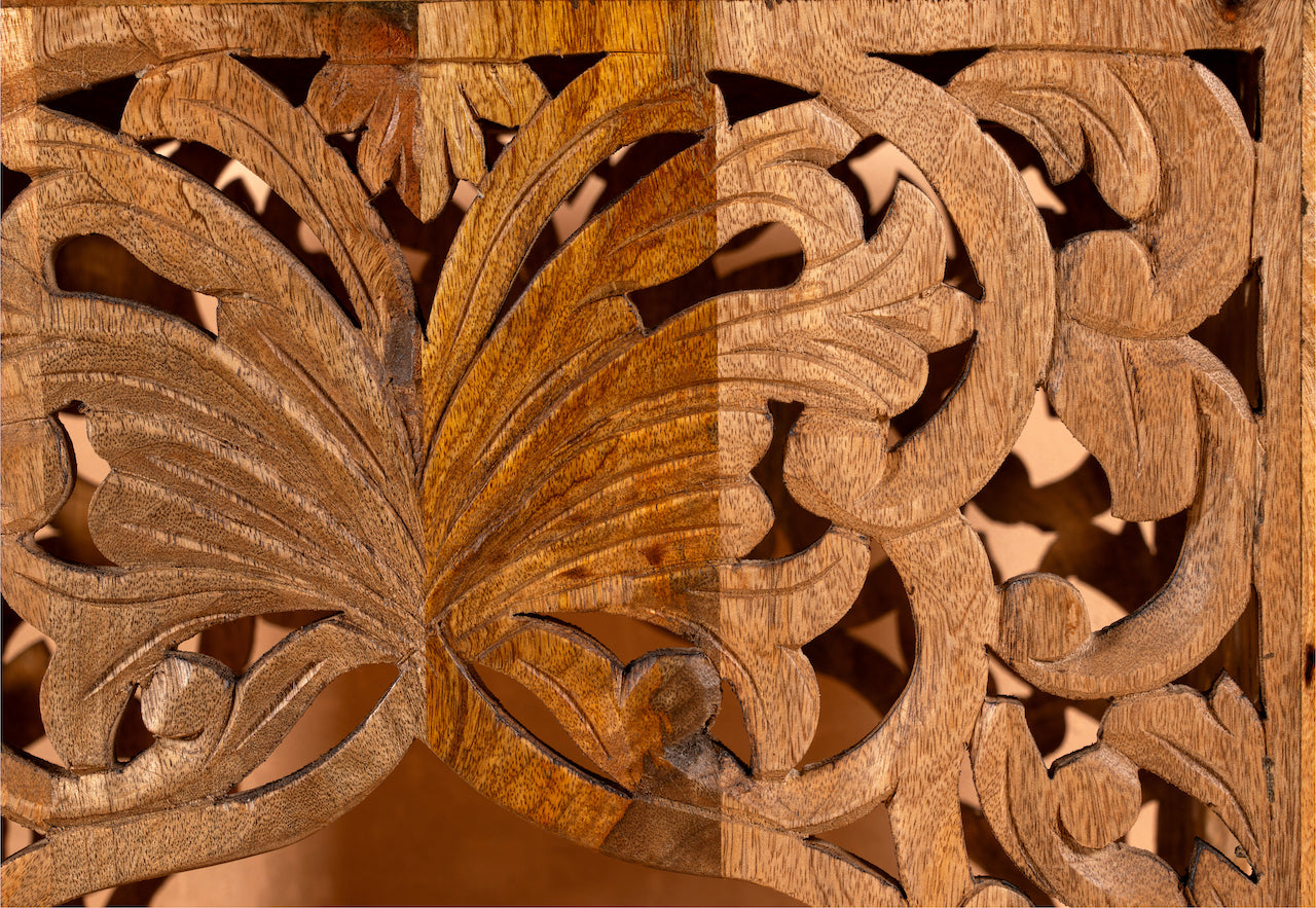 Close up image of the carvings of a square hand carved coffee table made from solid mango wood with intricate detailing; compact and rustic, 50 × 50 × 40 cm.
