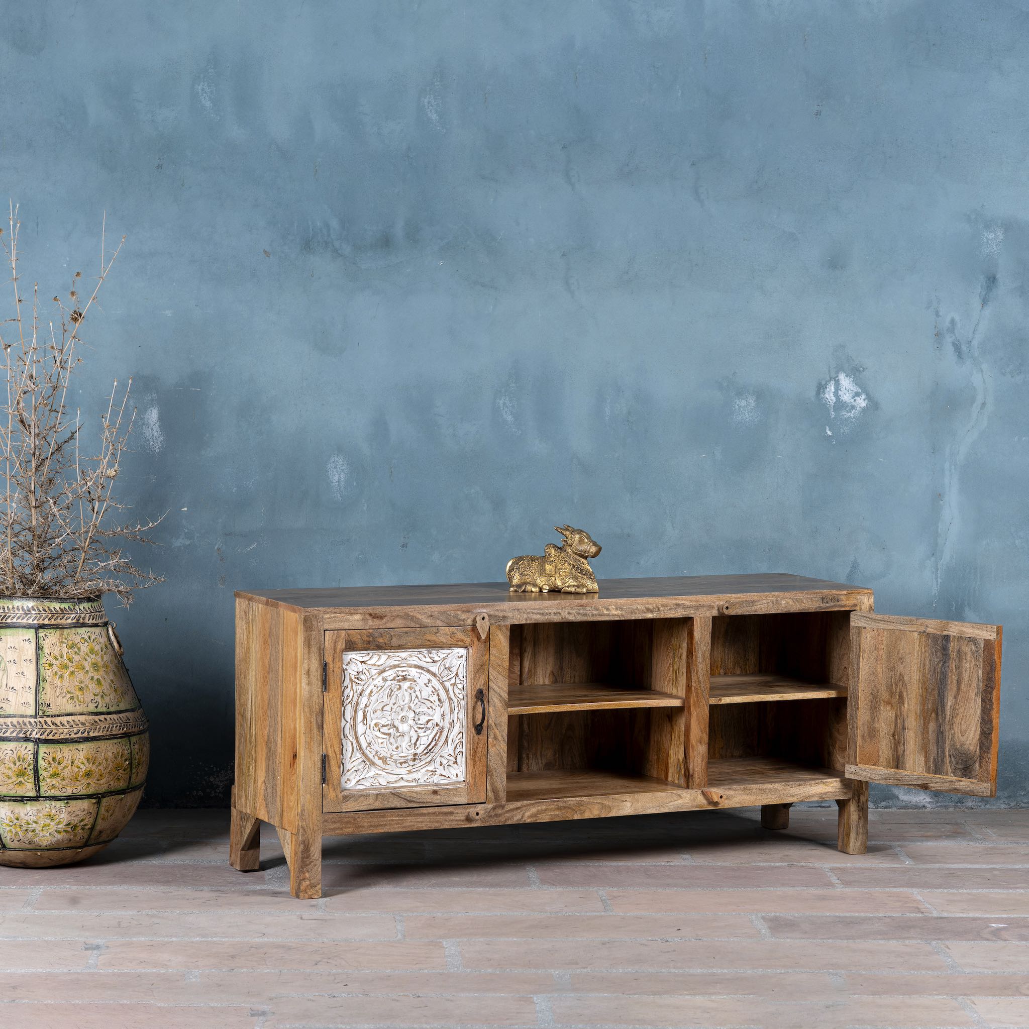 Open door image of a wood carved sideboard Alka, Indian furniture made from mango wood with floral carvings, whitewashed finish, 150 × 40 × 60 cm.