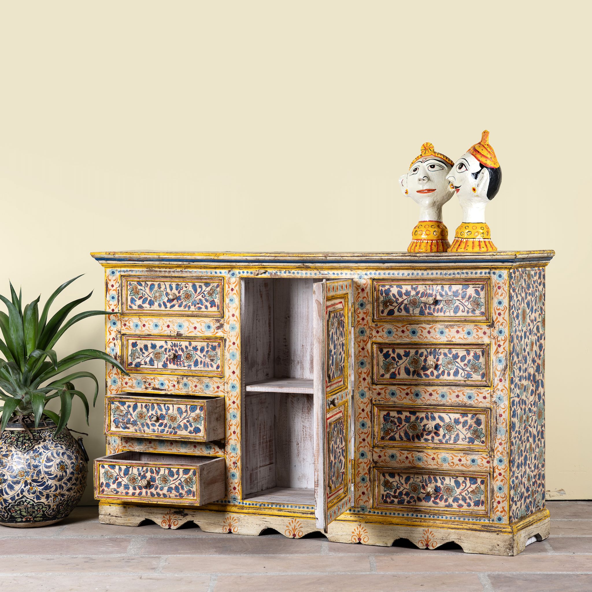 Side angle image showing open doors of a hand-painted reclaimed wood sideboard with floral motifs – a unique piece of sustainable furniture for vibrant Indian home decor.