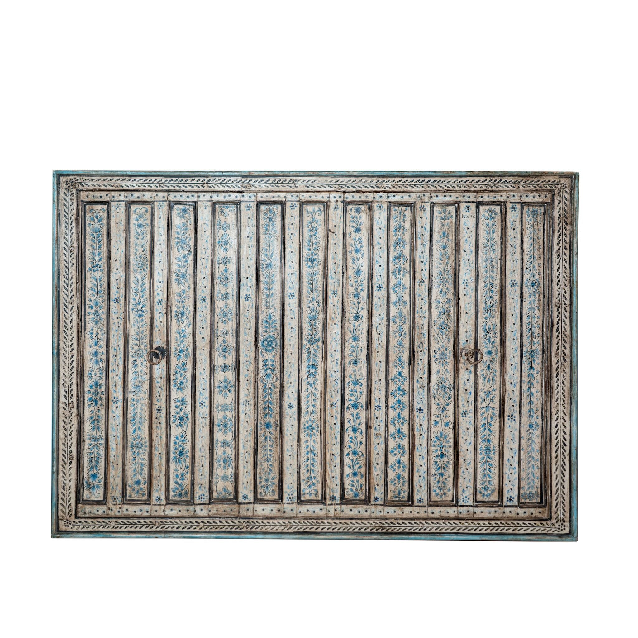 White background image of a Anmol hand painted head board made from an antique Indian teak door, featuring traditional floral motifs in blue and cream and original iron hardware—an elegant example of hand painted head boards and authentic Indian headboards.