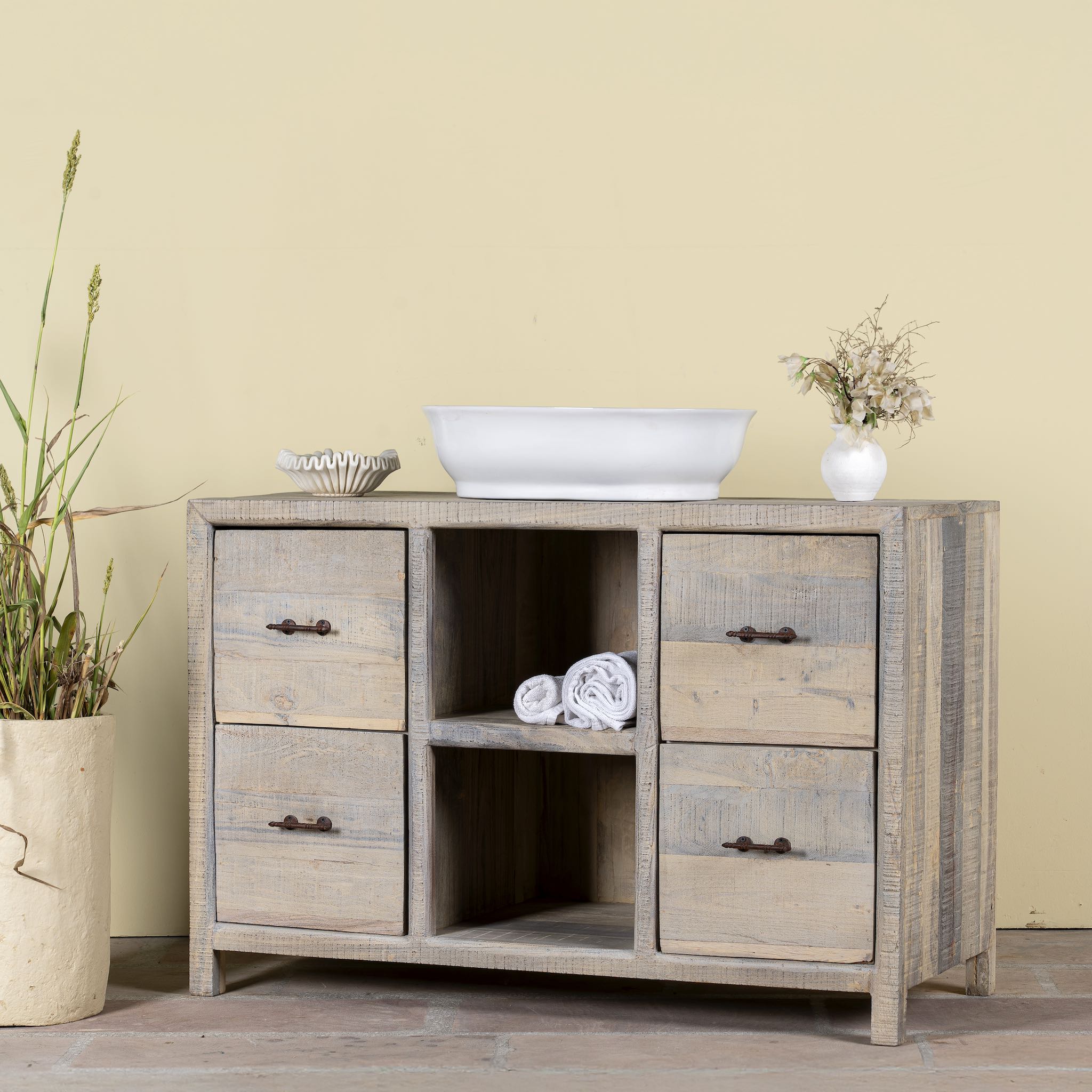 Side angle image of a reclaimed wood console with 6 drawers and 2 open shelves; Ibiza style bathroom console with matching Bhavya mirror available, 120 × 50 × 80 cm.