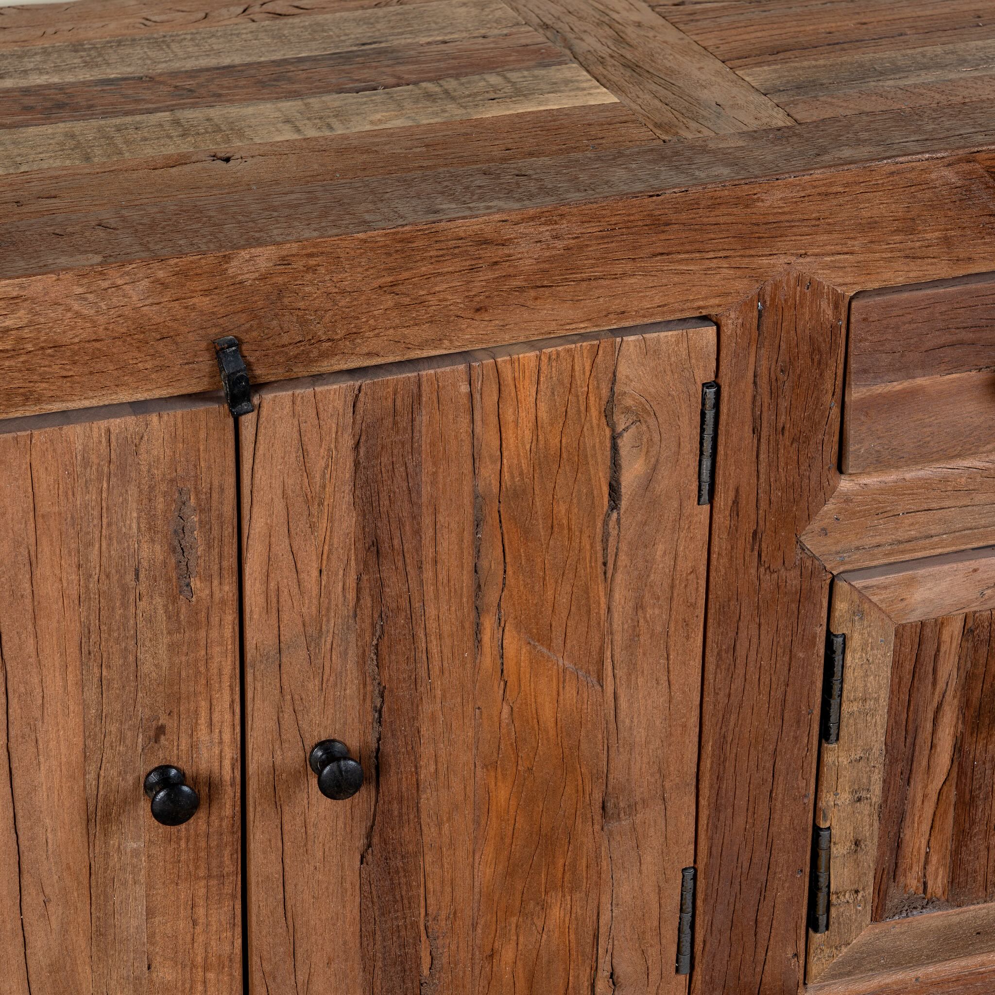 Close up image of a reclaimed wood lowboard Ariana in rustic minimalistic style with four cabinets and two drawers. A sustainable furniture piece offering functional storage and natural texture for modern living spaces.