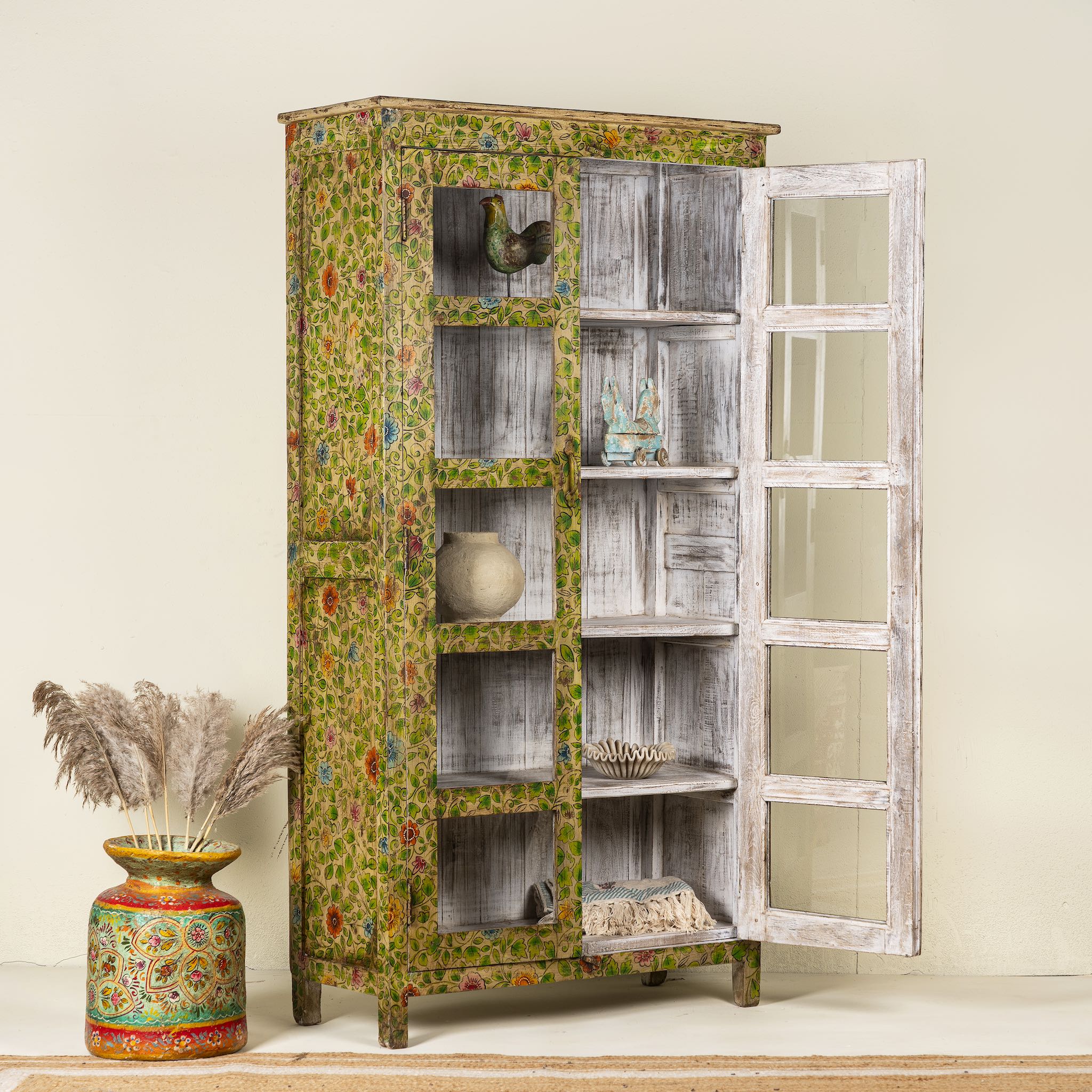 Side view image with open doors of a hand-painted reclaimed wood showcase cabinet with floral motifs and glass doors, sustainable furniture and vintage home decor style, 96 × 40 × 182 cm.