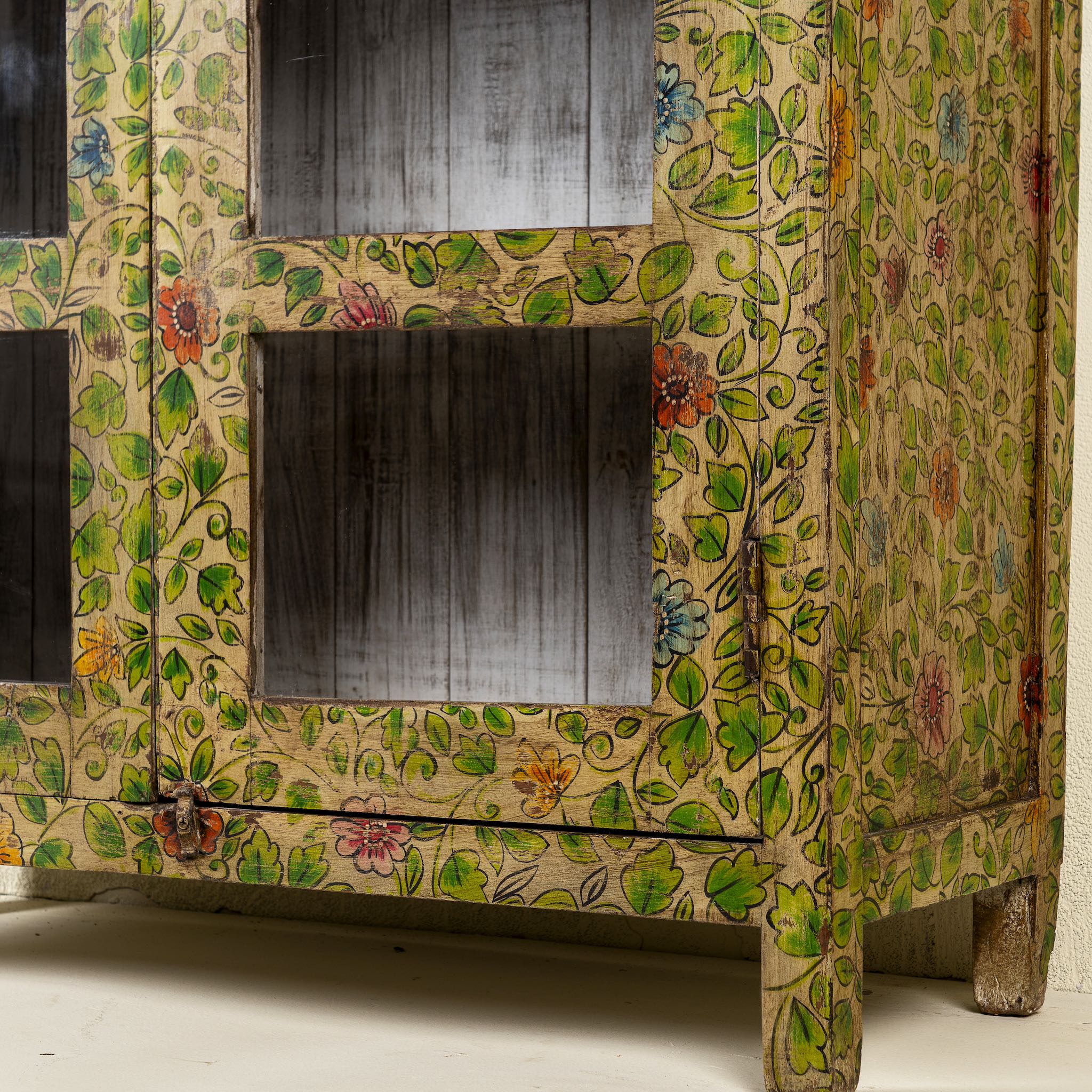 Close up picture of a hand-painted reclaimed wood showcase cabinet with floral motifs and glass doors, sustainable furniture and vintage home decor style, 96 × 40 × 182 cm.