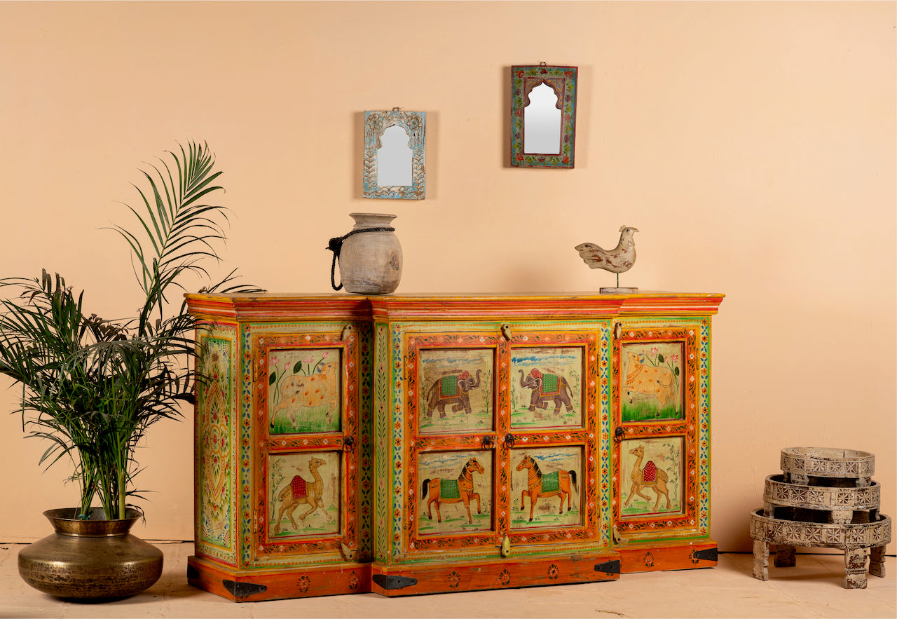Side angle image of a hand-painted reclaimed wood sideboard with Indian god motifs; unique hand painted furniture and Indian furniture online, 177 × 92 × 51 cm.