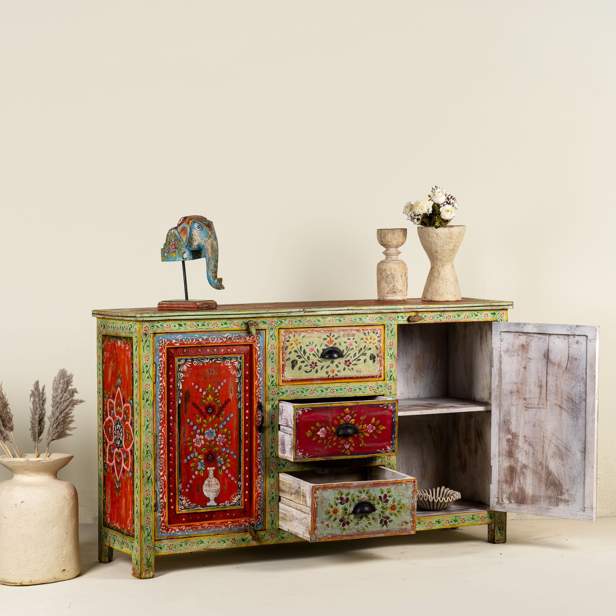 Open door image of a sustainable hand painted sideboard made from reclaimed teak wood with floral motifs; bold bohemian furniture, 150 × 45 × 90 cm.