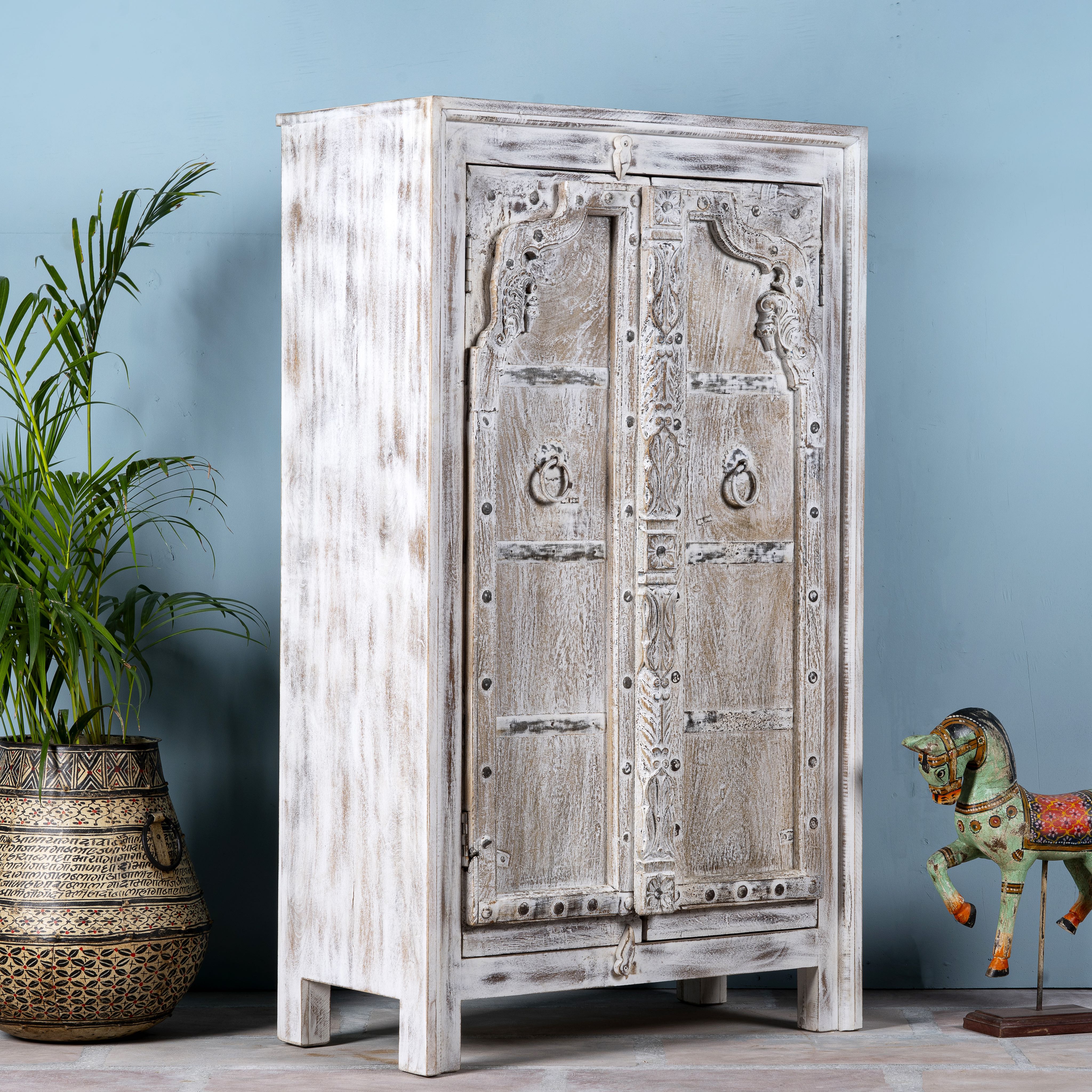 Side angle image of a handcrafted cabinet with reclaimed Indian window frame doors, white-washed finish, and iron accents – vintage home decor with teak furniture appeal.