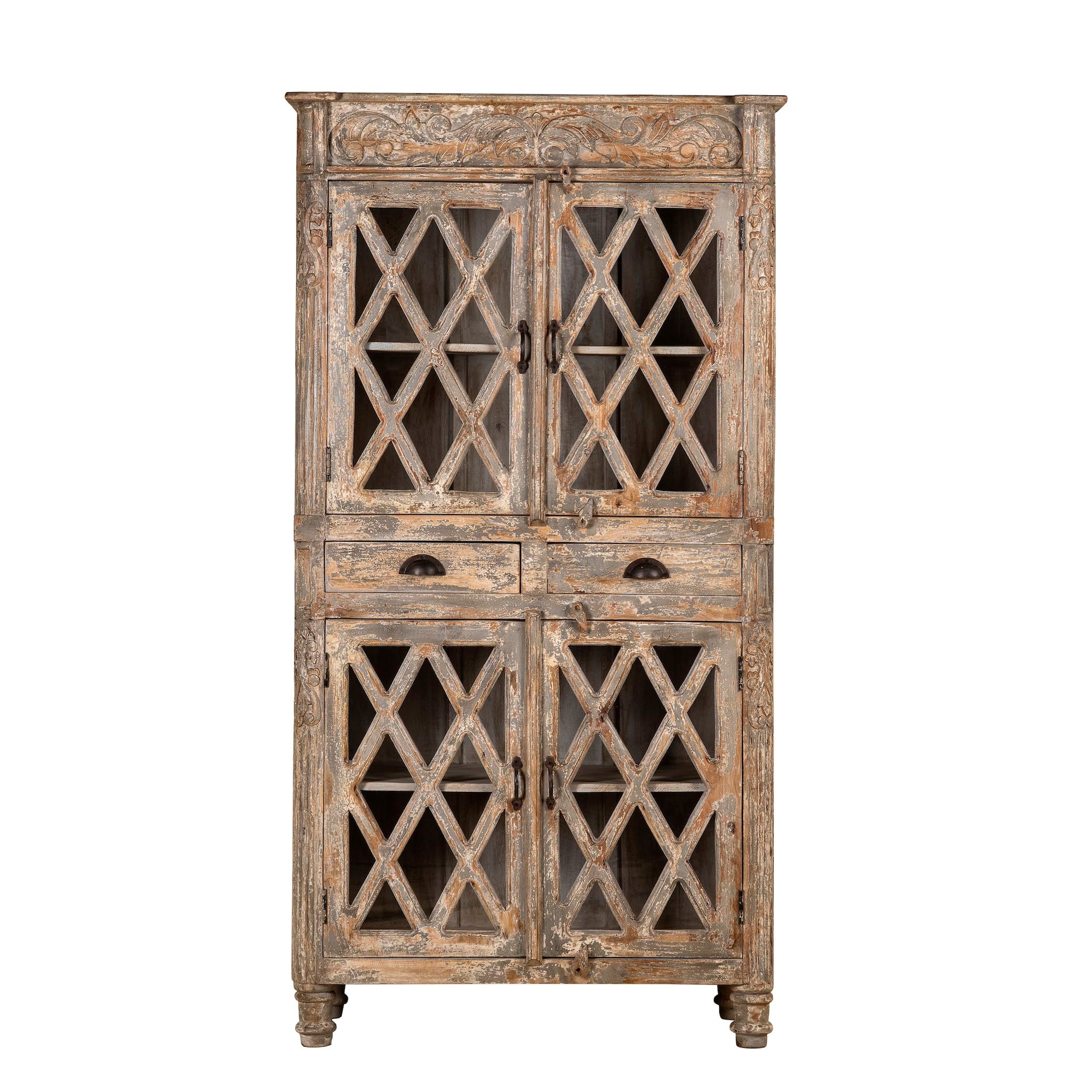White background image of a vintage display cabinet made from solid mango wood with glass doors and shelving – handcrafted Ibiza-style showcase with carved details.