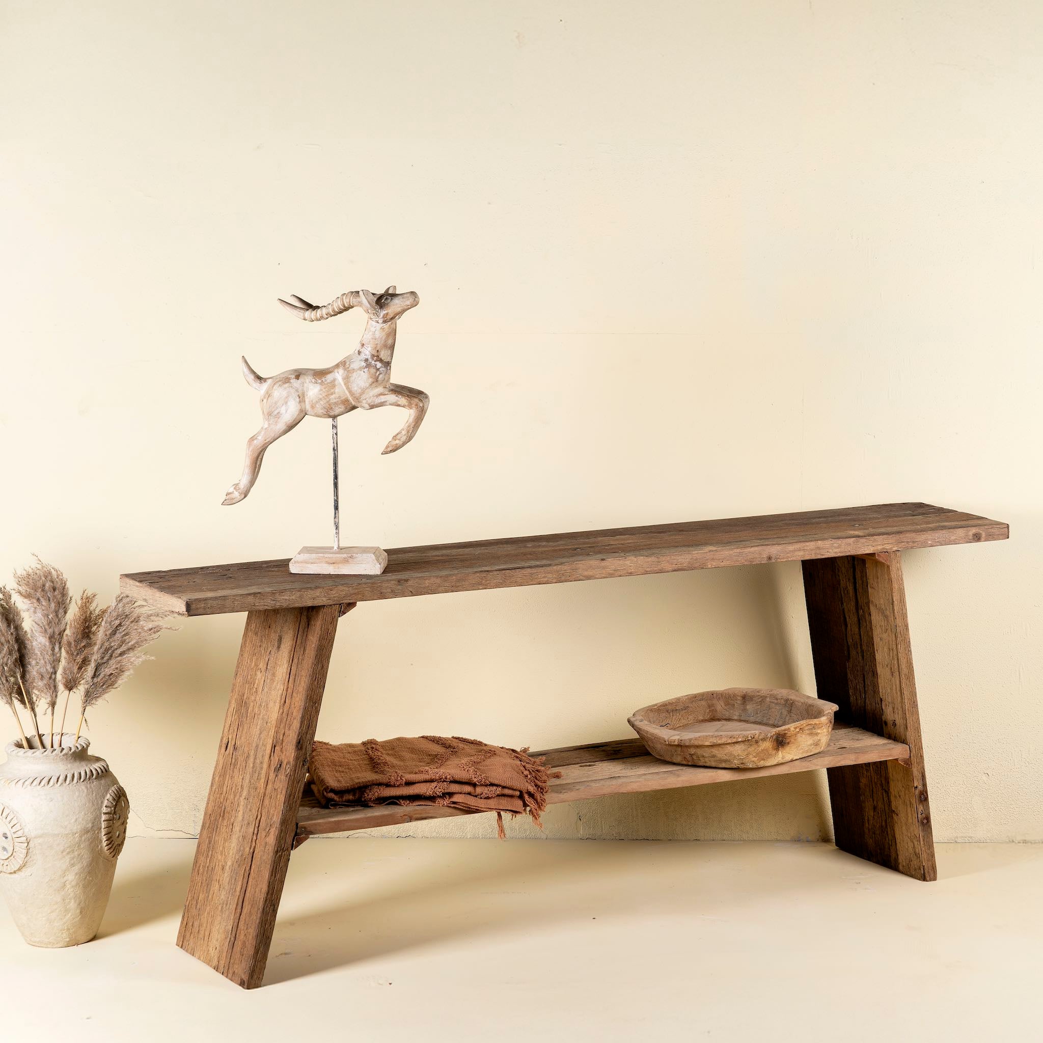 Front view image of a driftwood console table made from reclaimed wood, with lower shelf and weathered finish; sustainable furniture for entryways, 200 × 32 × 80 cm.
