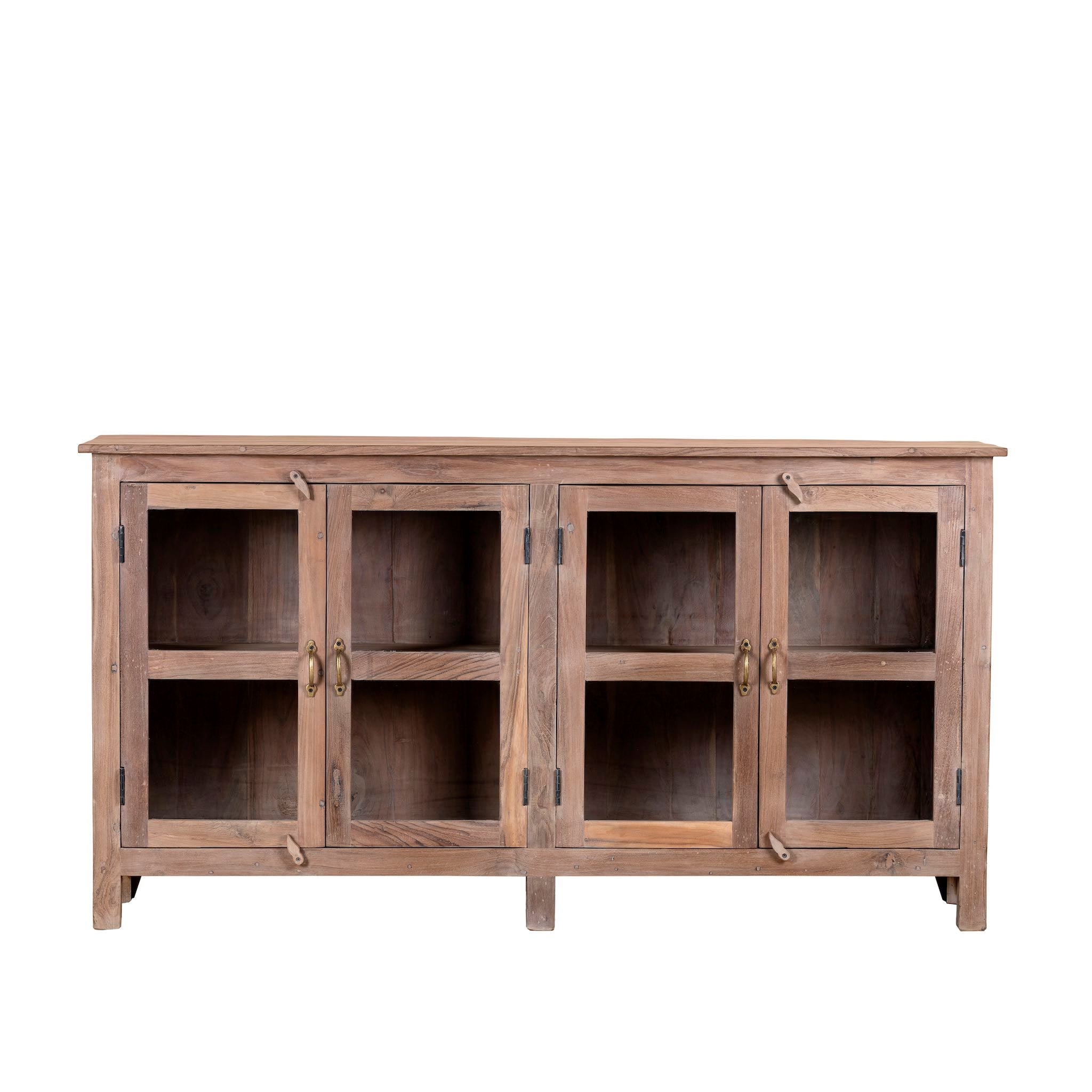 White background image of a rustic showcase cabinet made from recycled teak wood, featuring four glass-paneled doors with brass handles and a lightly weathered finish, offering a warm, natural look ideal for displaying decor or tableware.