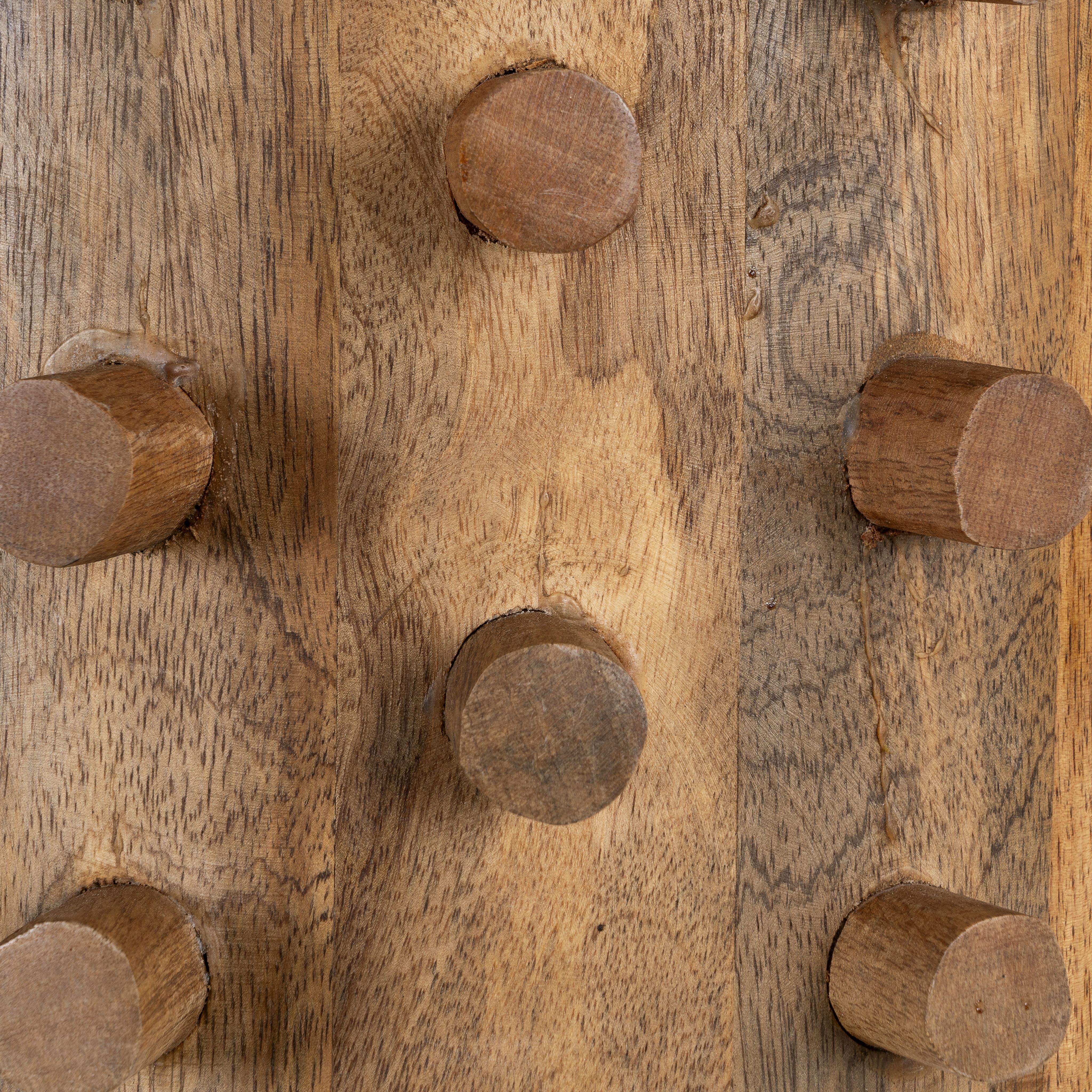 Close up image of a wooden vintage pendant lamp made from carved mango wood with tree design and brass-plated hanging – a unique piece of mango wood lighting for dining rooms, living spaces, or entryways.