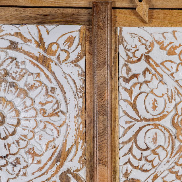 Close up image of a mango wood wardrobe with whitewashed floral carvings, vintage furniture cabinet in carved wood, 190 × 105 × 42 cm.
