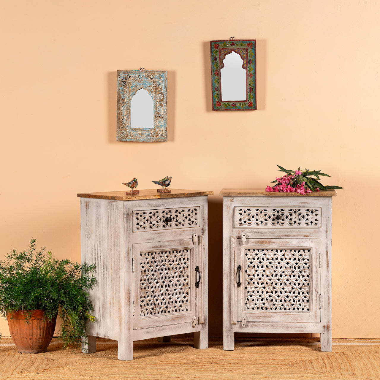 Side angle image of a pair of carved nightstands made from mango wood with geometric patterns and distressed finish; perfect bedroom furniture, 76 × 56 × 35 cm.