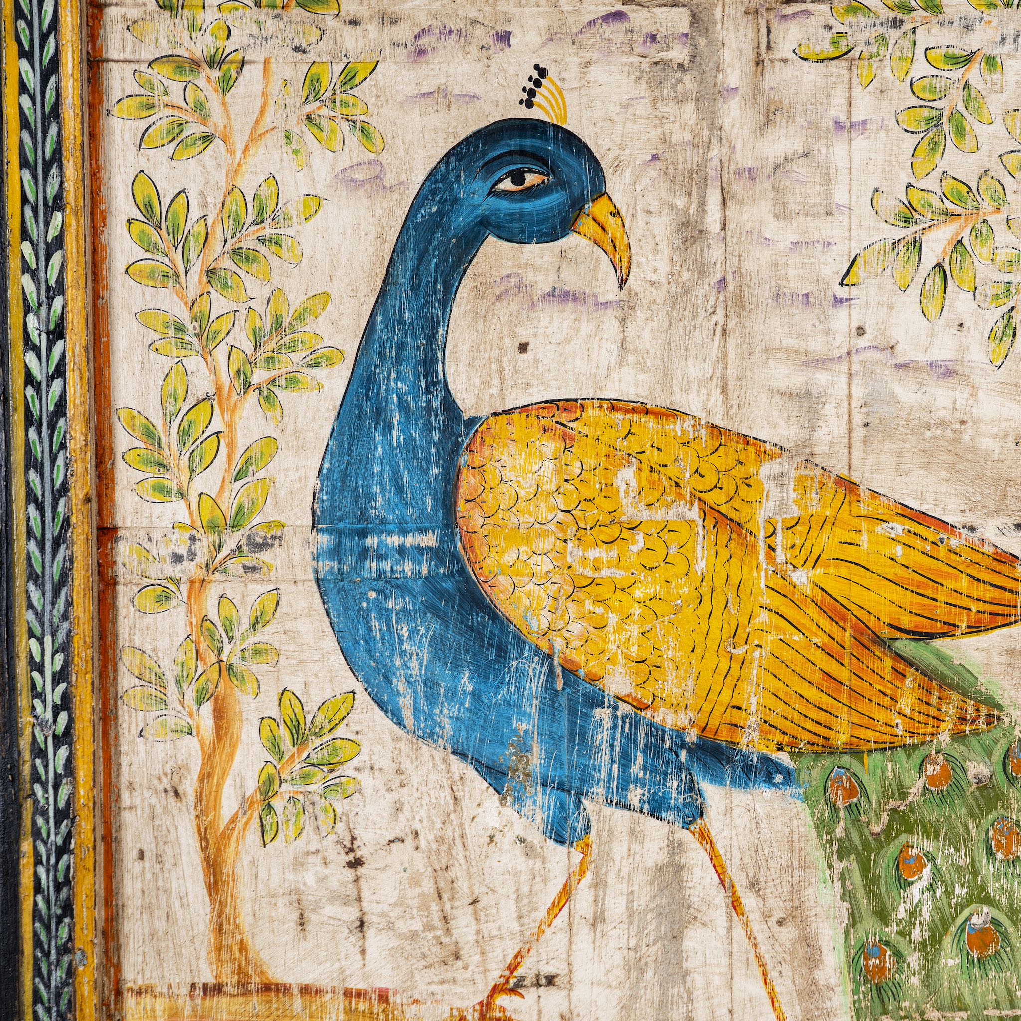 Close up image of a hand-painted wooden wall panel made from an old teak door with peacock motif; vintage wall panels and India home accessories, 88 × 8 × 171 cm.
