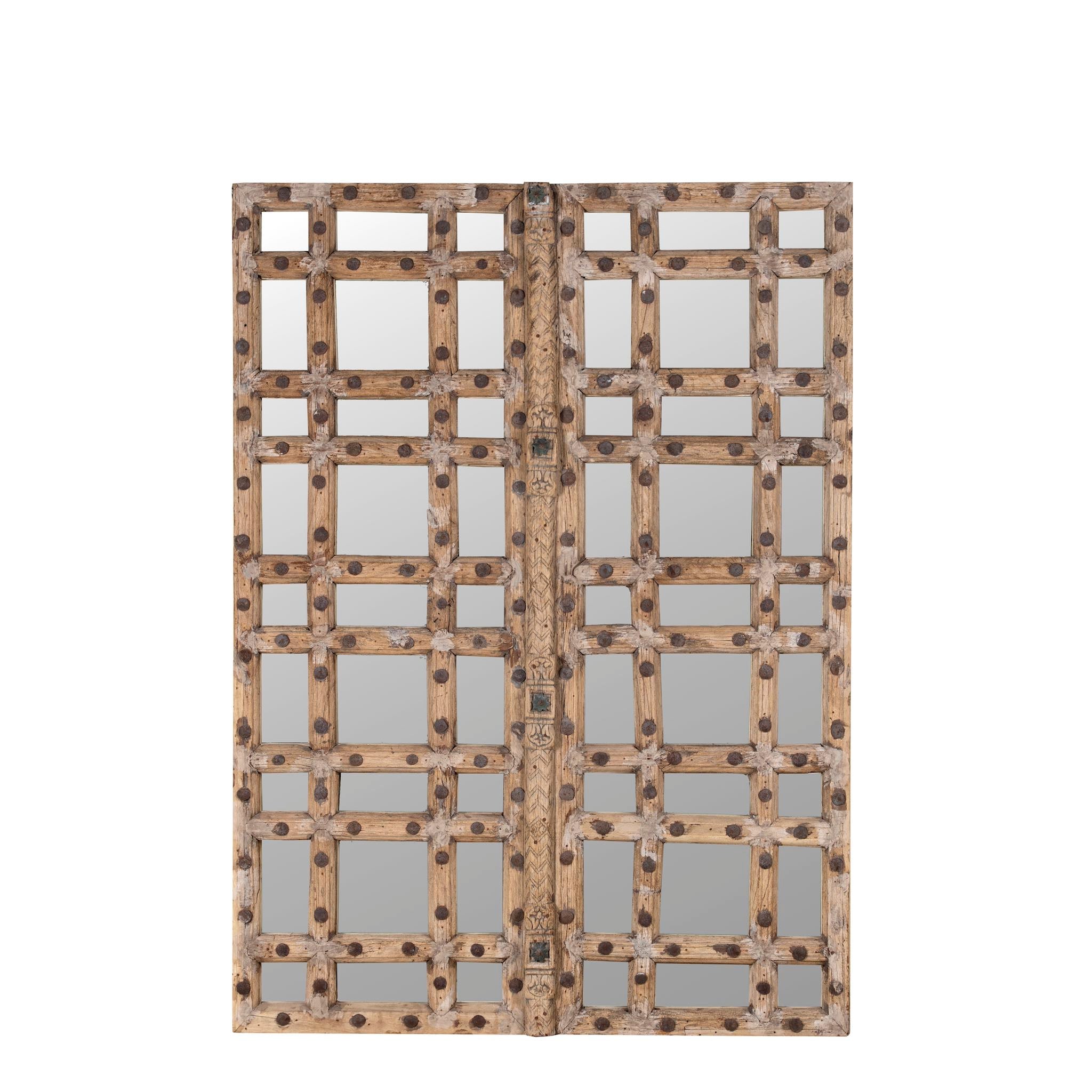 White background picture of a reclaimed teakwood mirror crafted from an antique Indian door panel, featuring iron accents and mirror inlays – ideal for vintage home decor and heritage-inspired interiors.