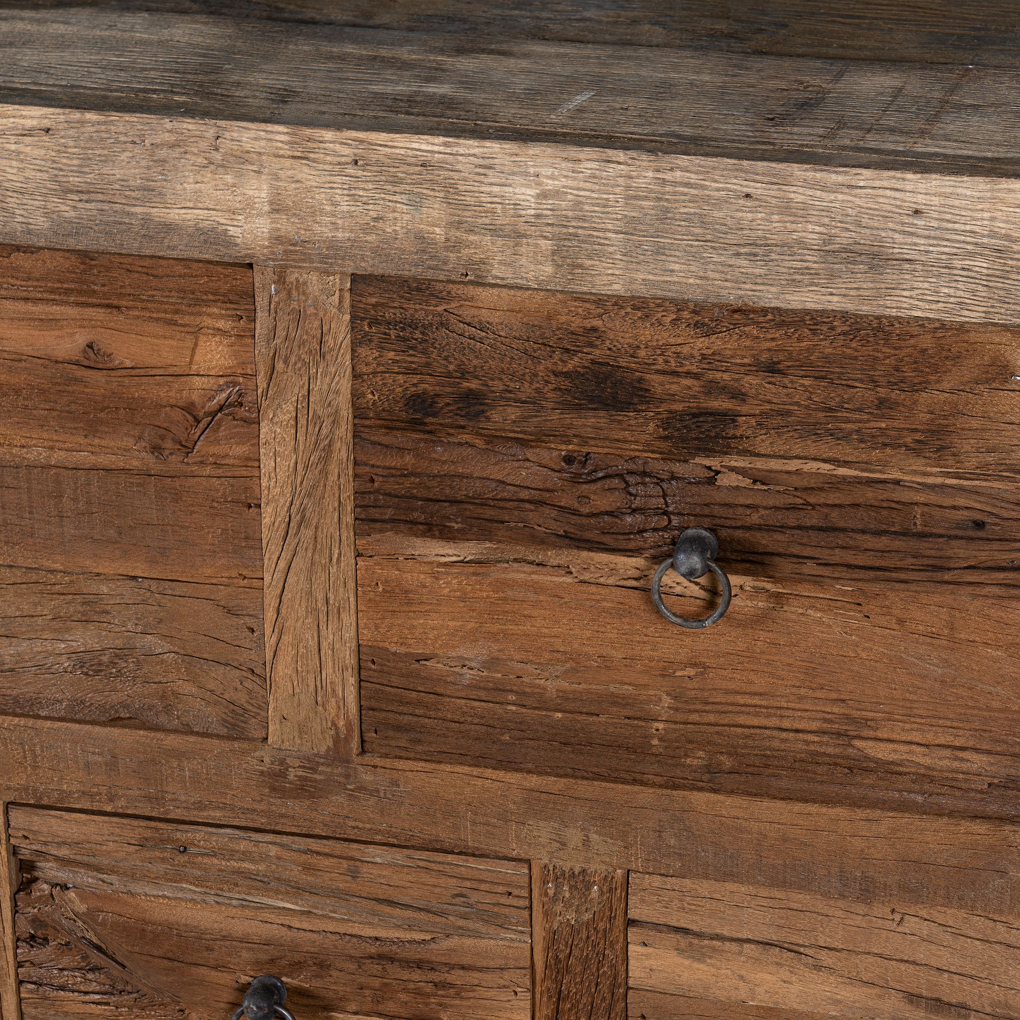 Close up image of a reclaimed wood console table with rustic finish, multiple drawers, and iron ring pulls; sustainable furniture with driftwood charm, 250 × 40 × 85 cm.