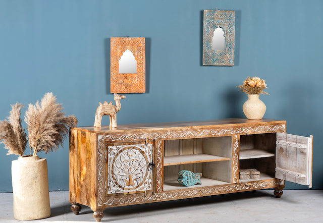 Side angle image of a whitewashed carved console table made of mango wood with floral motifs, four compartments; artisanal living room furniture, 180 × 40 × 65 cm.