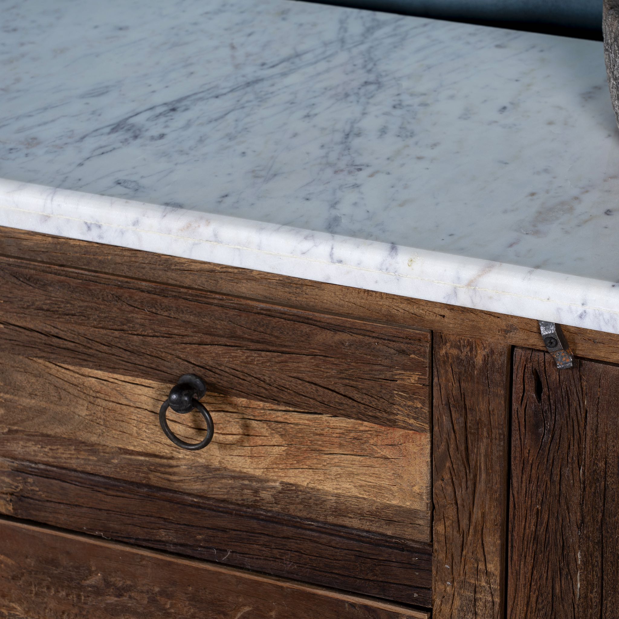 Close up image of a wabi sabi furniture driftwood sideboard with white marble top, minimalist Japandi cabinet with drawers and sliding surface, 125 × 35 × 75 cm.