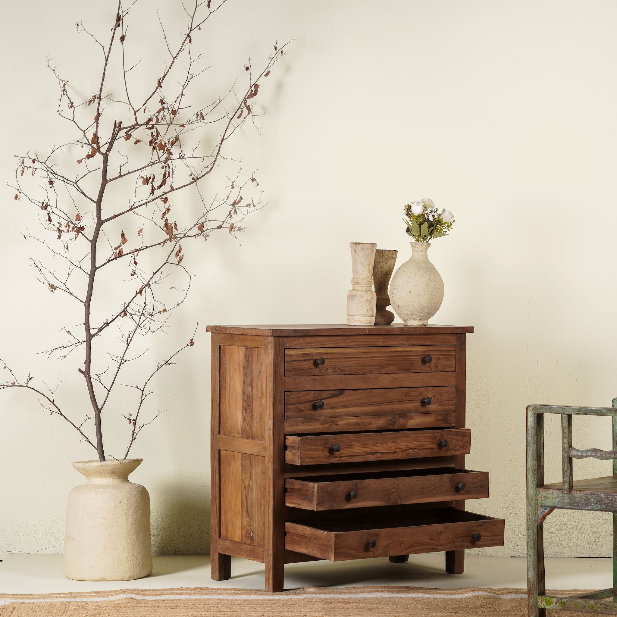 Side angle view with open drawers of a chest of drawers made from reclaimed teak wood, featuring a minimalist design with five spacious drawers and a warm natural finish- ideal for rustic and modern interiors.
