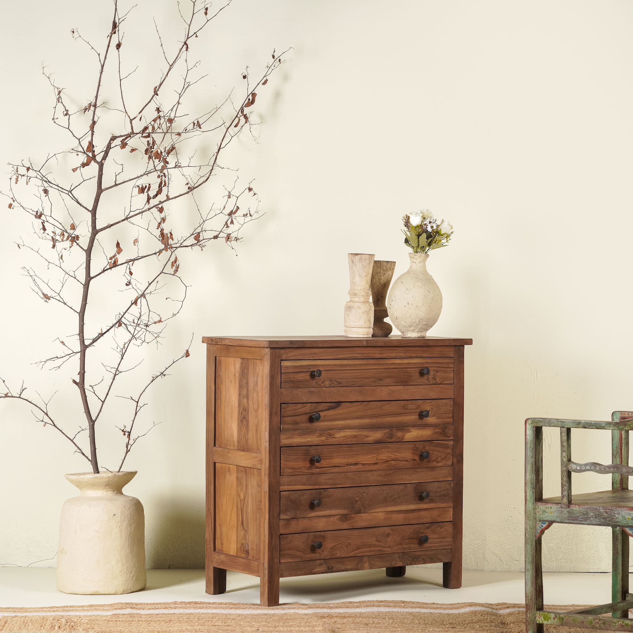 Chest of drawers made from reclaimed teak wood, featuring a minimalist design with five spacious drawers and a warm natural finish- ideal for rustic and modern interiors.