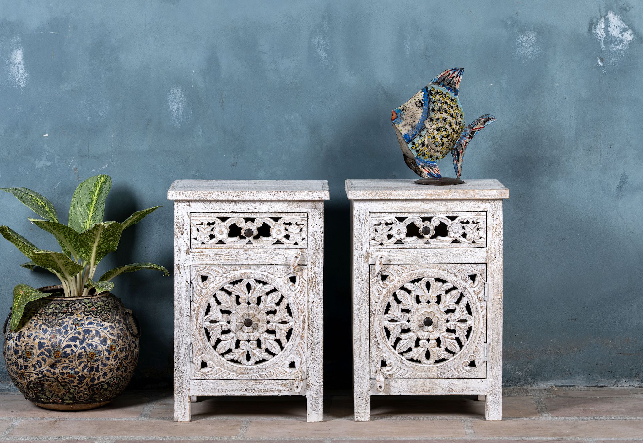 Whitewashed nightstand made of mango wood with Mediterranean-style carved detailing and one drawer – Gagan bedside table by Om Home & Garden