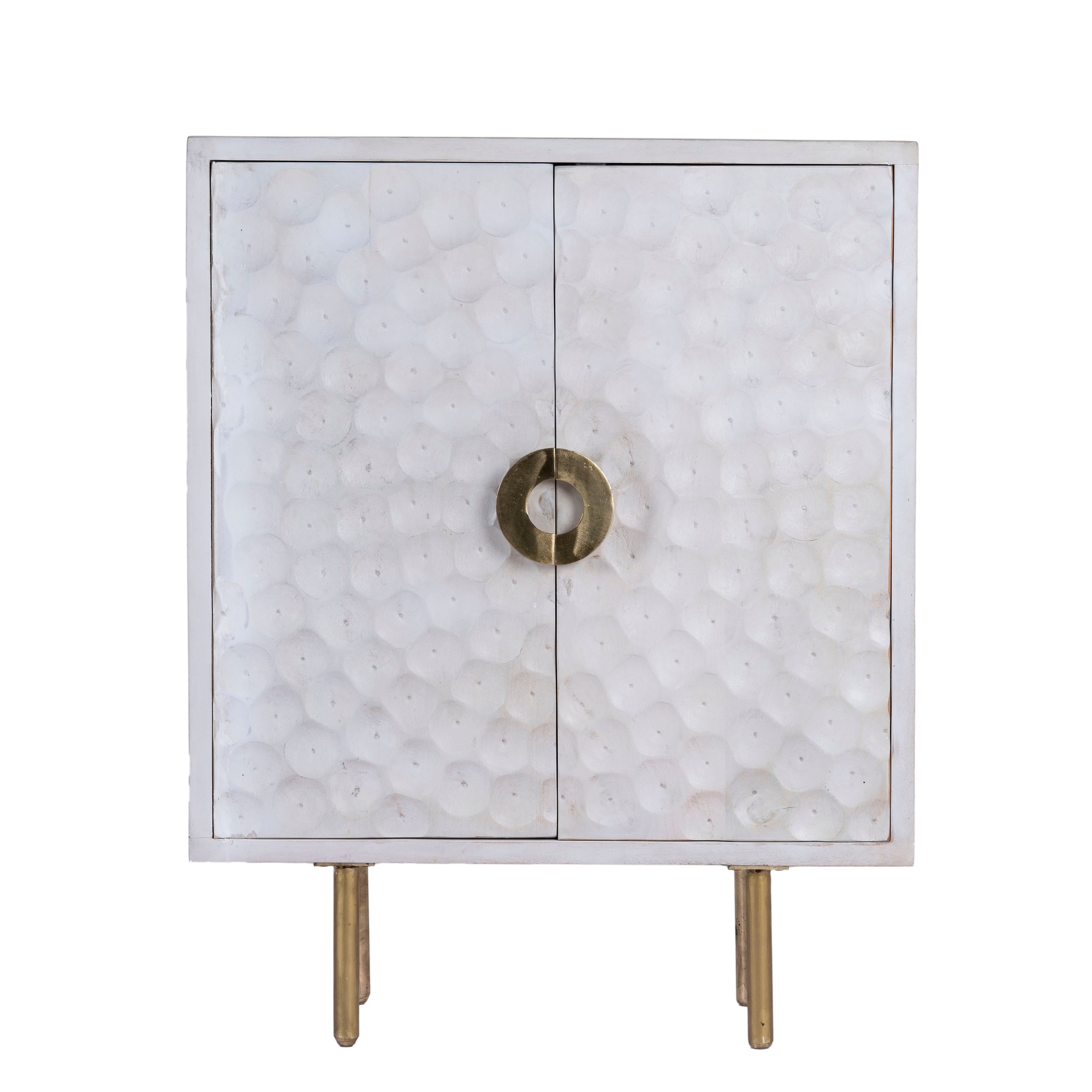 White background image of a carved wood furniture cupboard in white mango wood with hammered pattern, brass iron base, 88 × 43 × 122 cm.