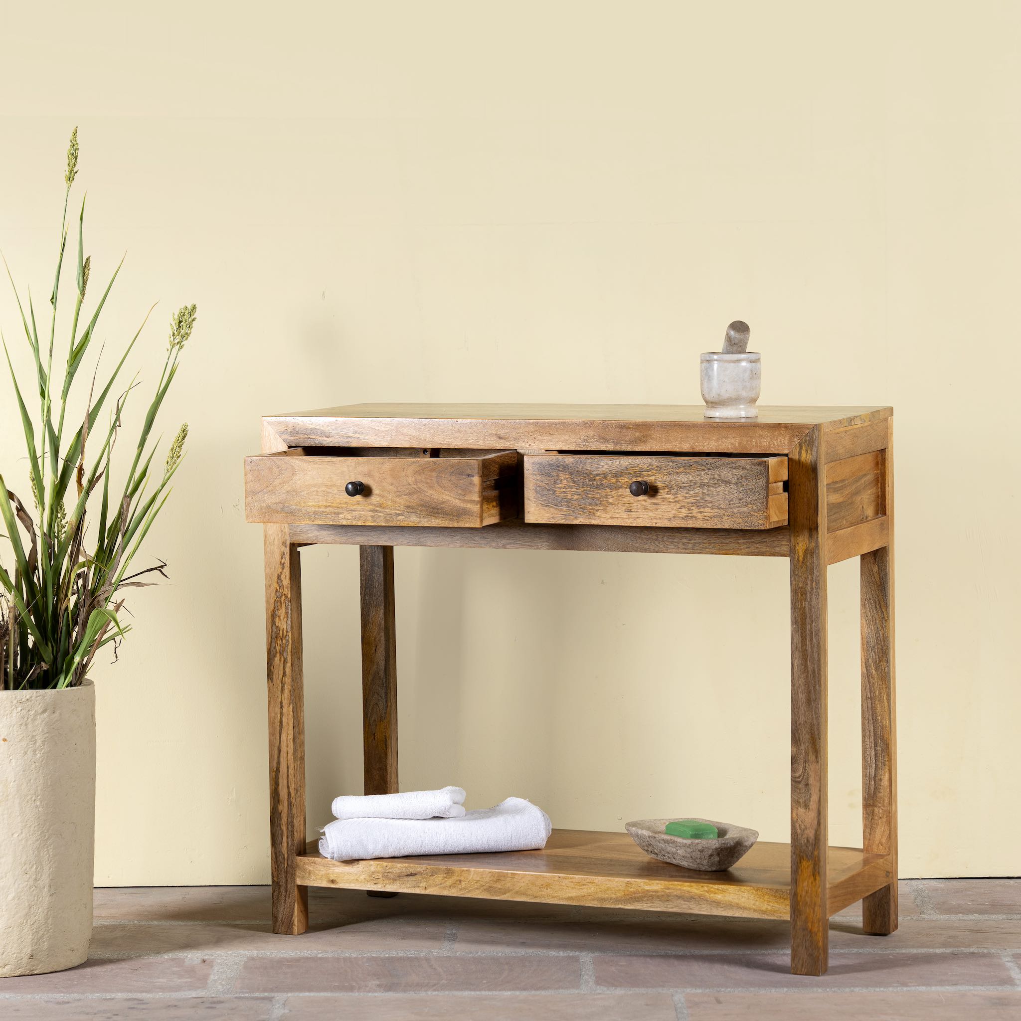 Open drawer image of a Ibiza style reclaimed wood console table with two drawers and bottom shelf, warm natural finish, 100 × 40 × 90 cm.