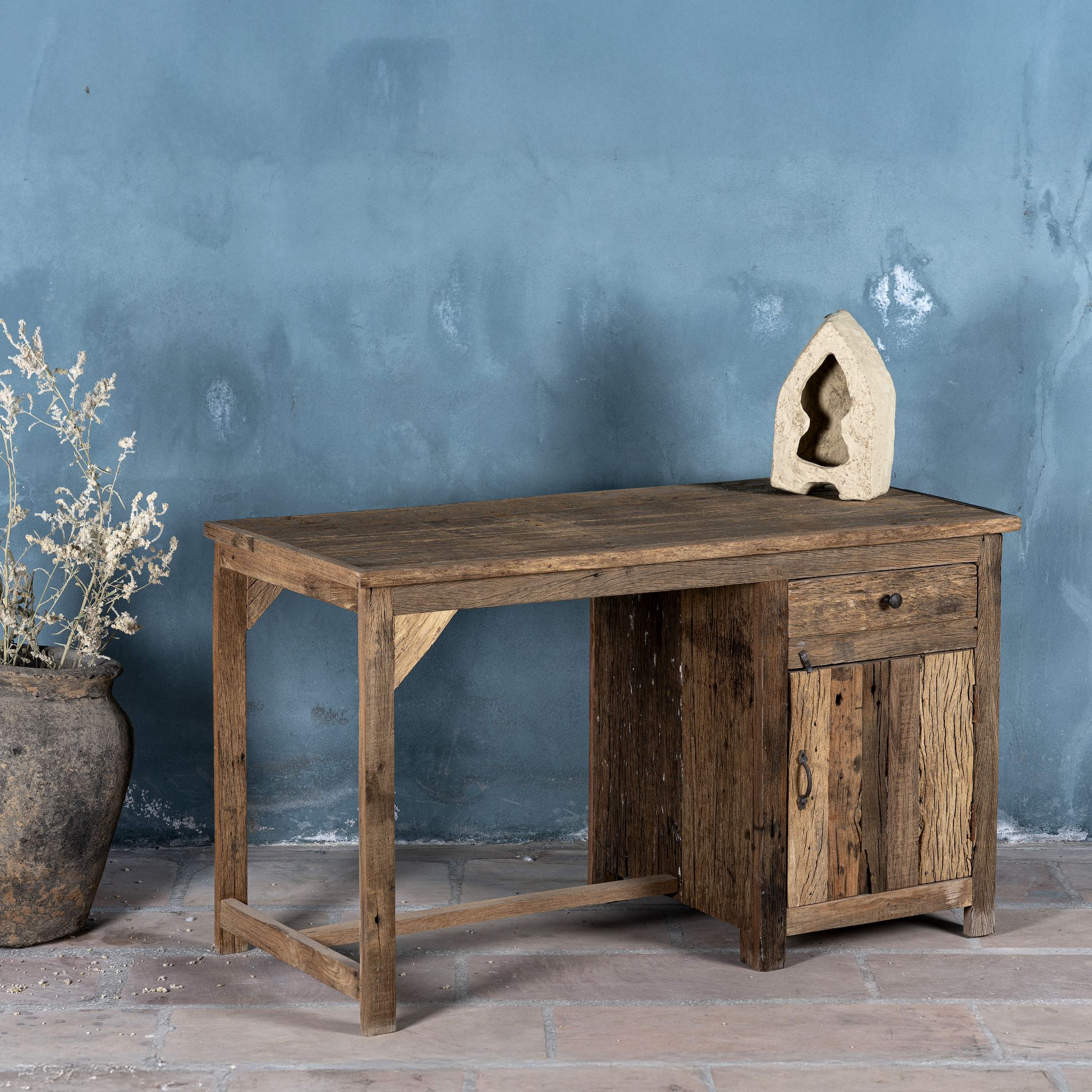 Side angle image of a rustic minimalist wooden desk made from reclaimed old wood with drawer and cabinet, 130 × 60 × 75 cm.