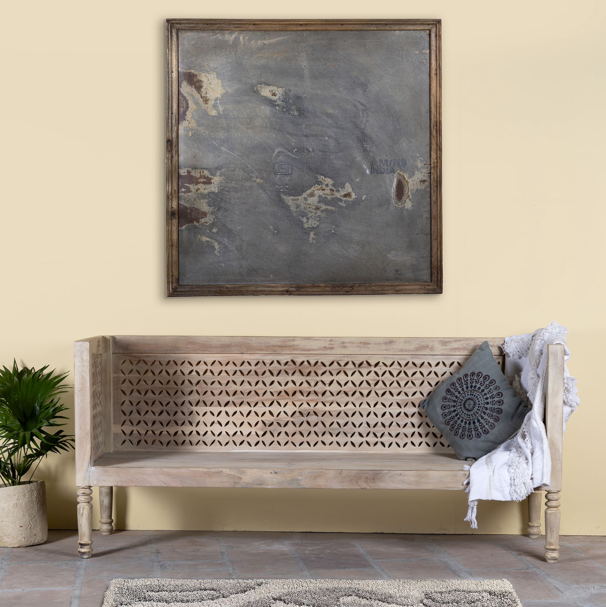 life style image of a hand-carved reclaimed wood bench with geometric backrest design, sandblasted Ibiza style finish, ideal for boho chic living room interiors, 176×56×95 cm.