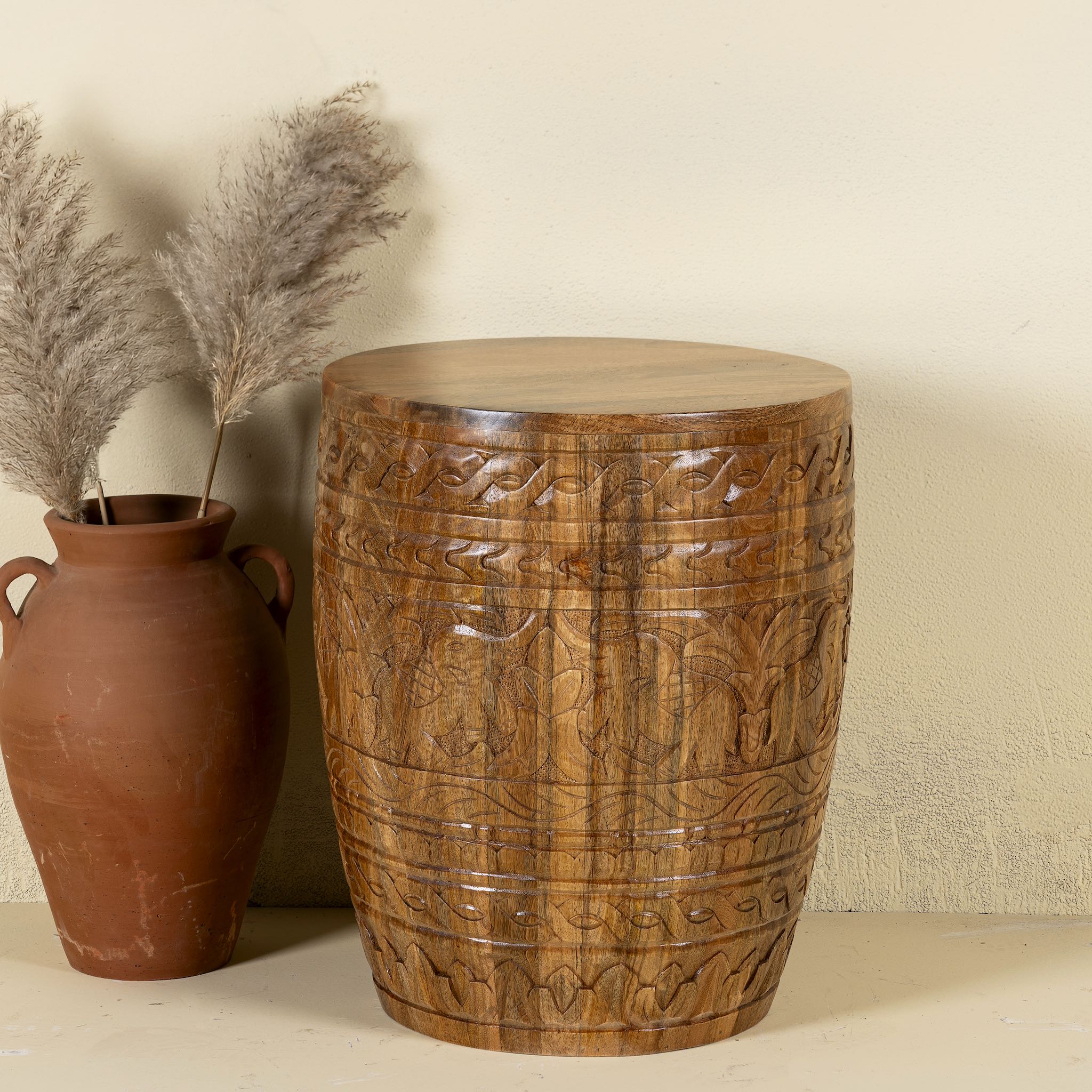 Hand-carved mango wood coffee table with barrel shape and warm rustic finish; vintage style coffee table, 45 cm diameter, 55 cm height.
