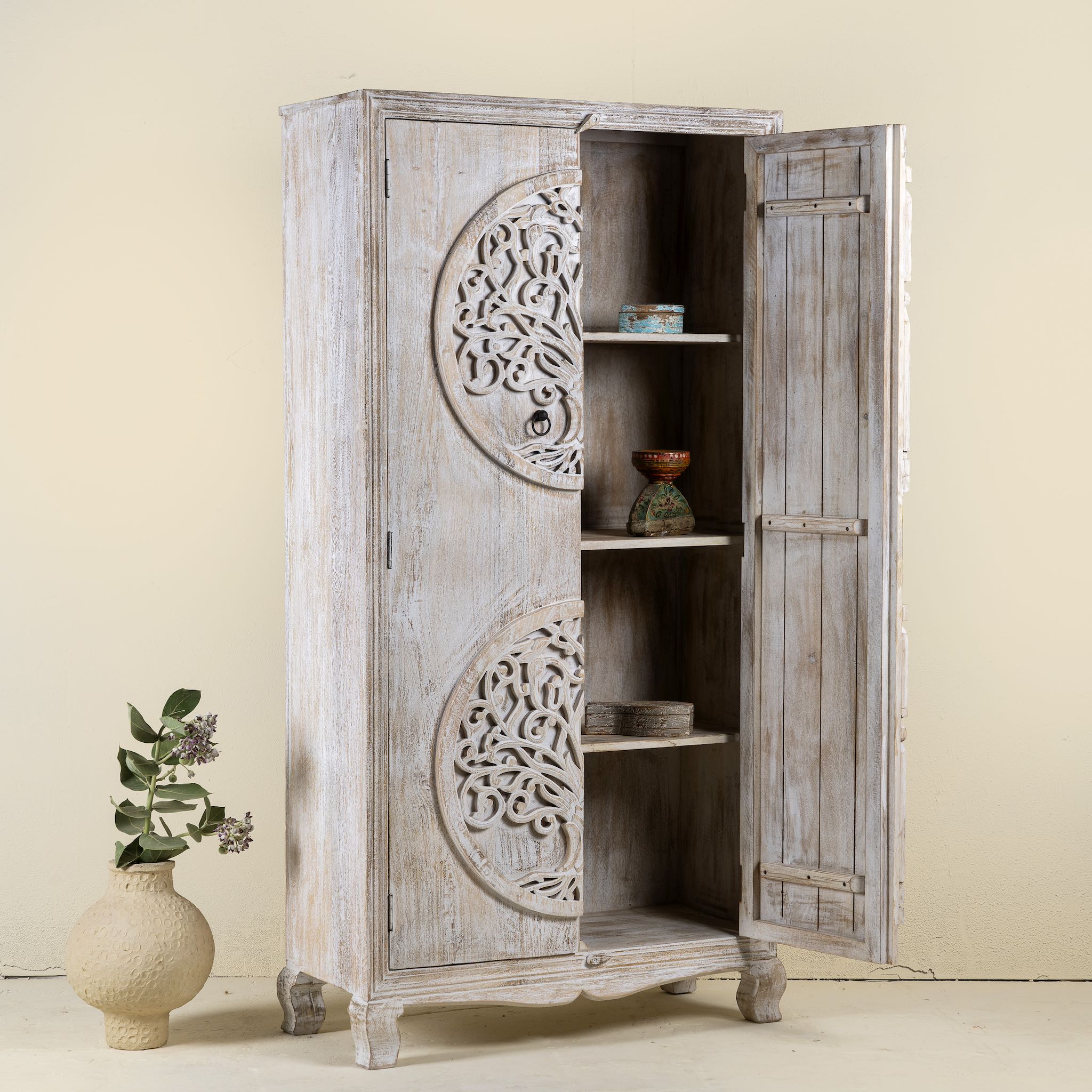 Open door image of a white washed armoire with hand-carved Tree of Life motif, mango wood carved wood furniture with storage, 90 × 40 × 180 cm.