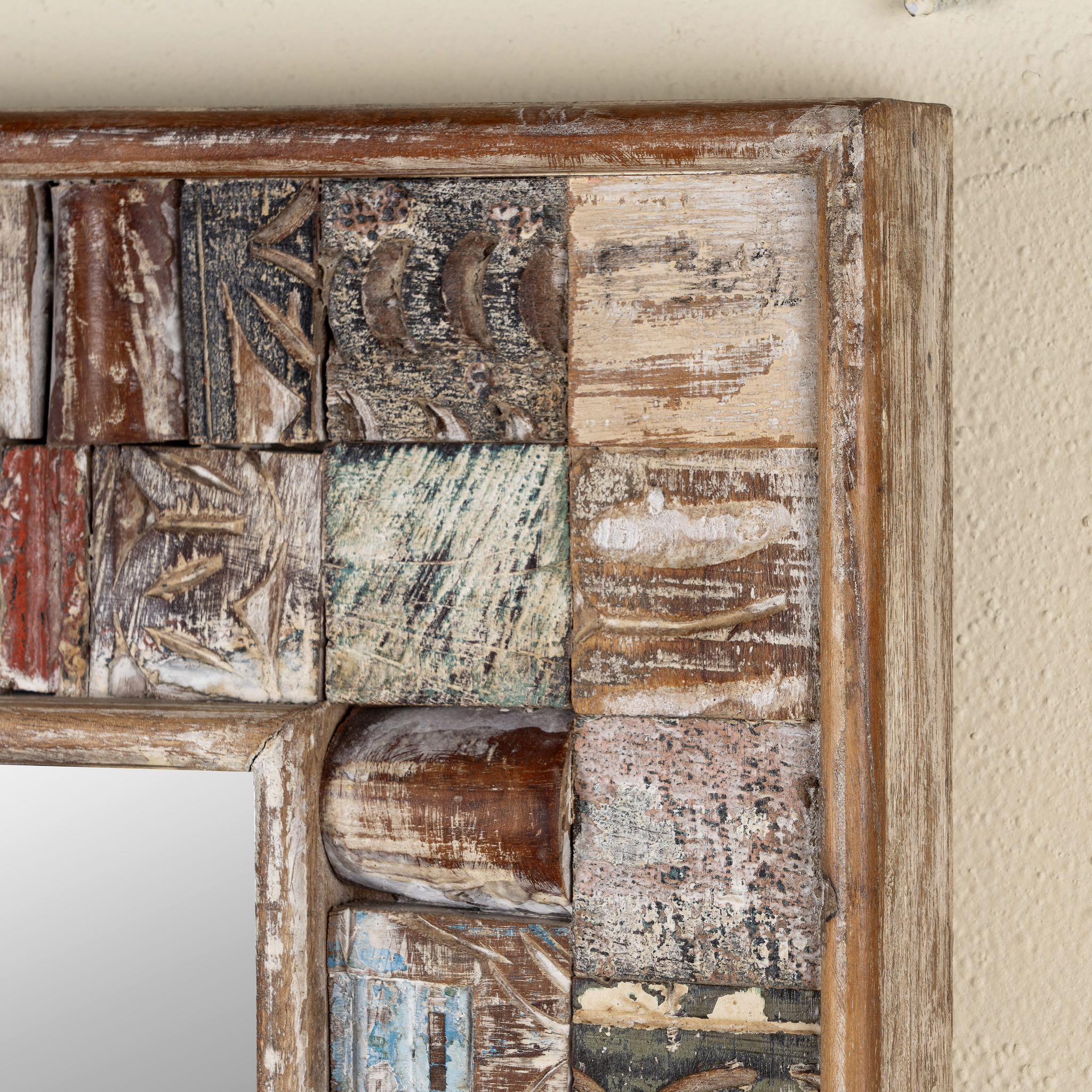 Close up image of a rectangular mango wood mirror with reclaimed wood patchwork frame and distressed finish; perfect for vintage home decor and bohemian styling, 64 × 5 × 84 cm.