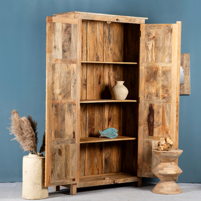 Open door image of a hand carved wooden wardrobe made of solid mango wood with whitewashed floral details; Ibiza-style mango wood wardrobe, 190 × 100 × 40 cm.