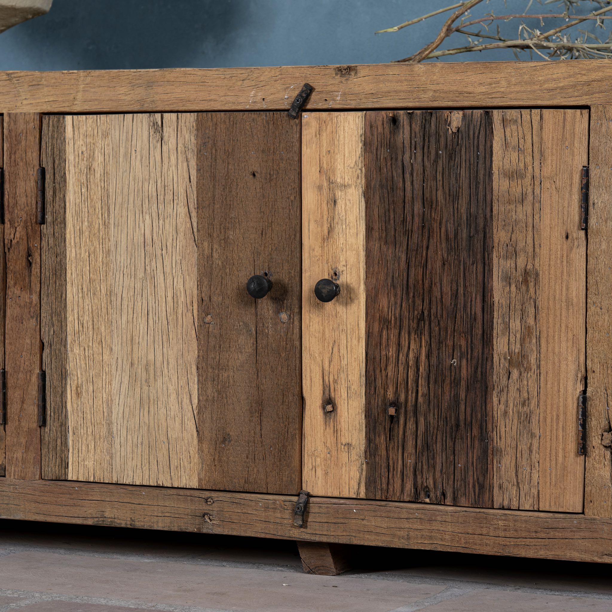 Close up image of a sustainable driftwood furniture lowboard made from reclaimed wood with four cabinets and rustic finish; 230 × 45 × 60 cm.