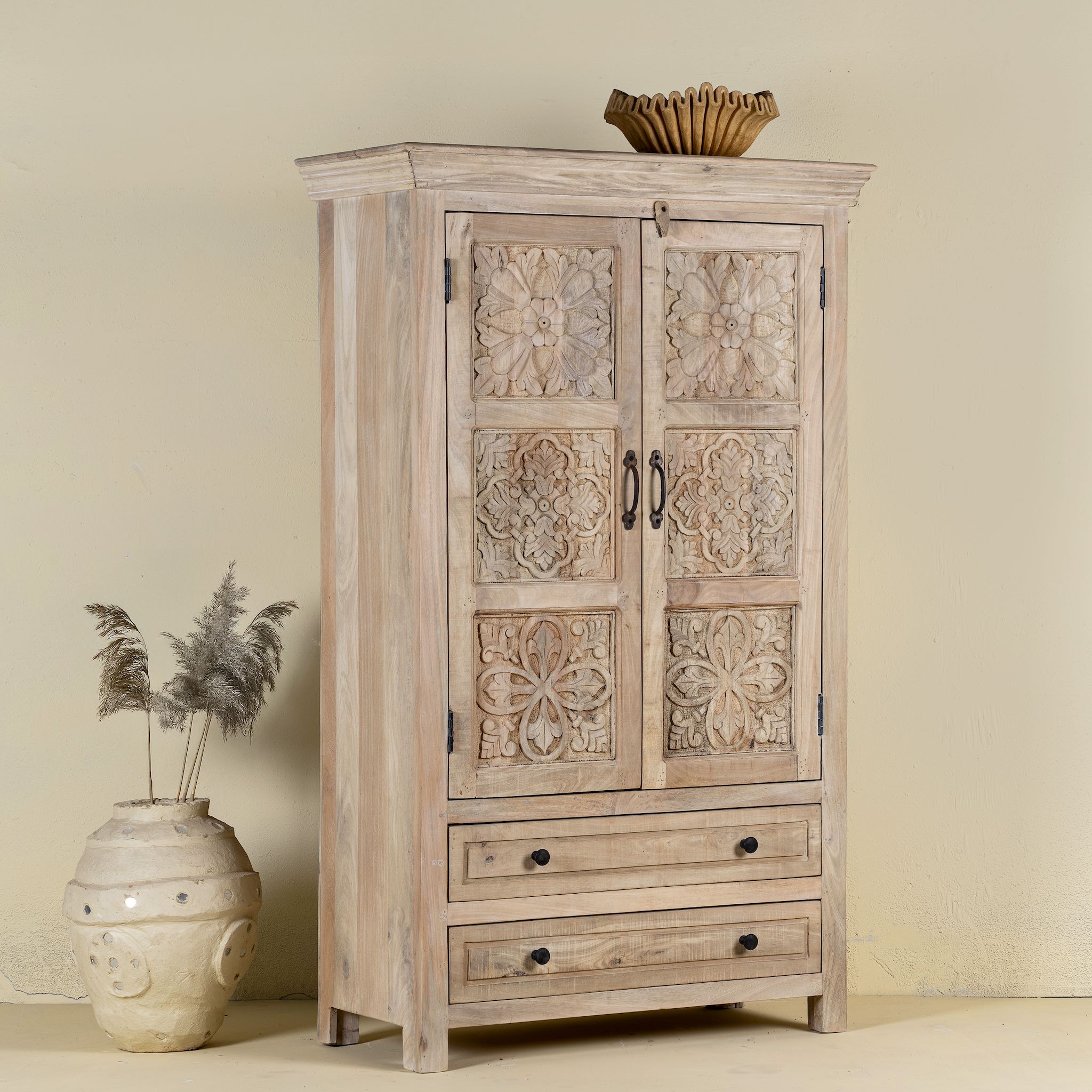 Side view of a hand-carved mango wood cabinet with floral and geometric detailing – carved wooden furniture and elegant bedroom storage by Om Home & Garden.