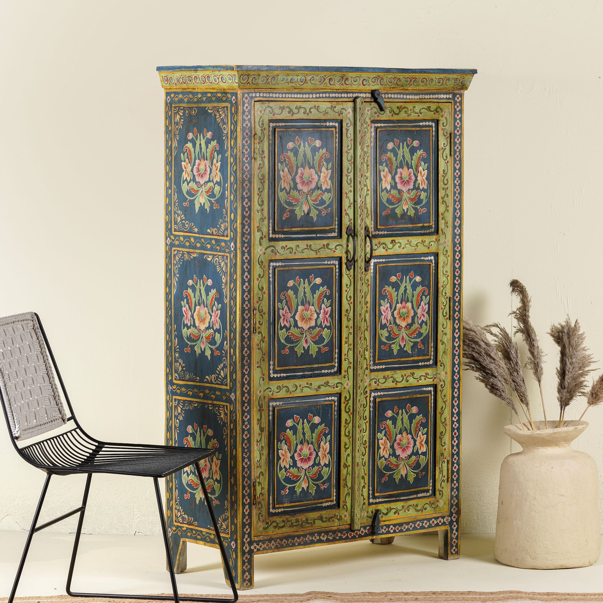 Side angle image of a hand painted wardrobe made of reclaimed wood with floral motifs; unique furniture for bedrooms or living rooms, 90 × 45 × 150 cm.