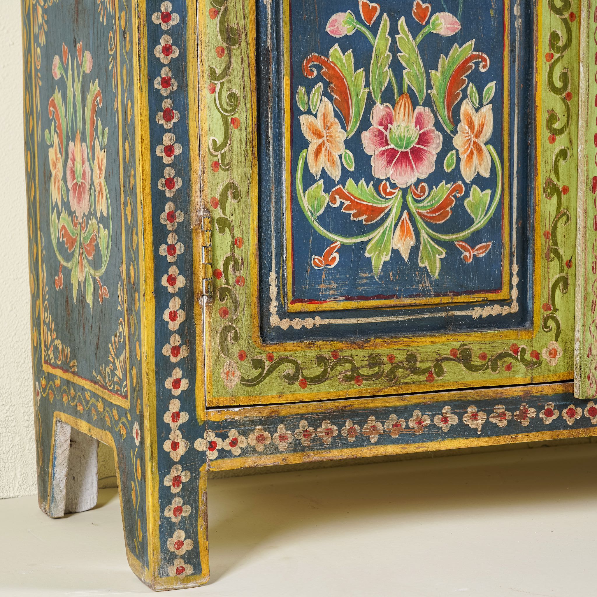 Close up image of a hand painted wardrobe made of reclaimed wood with floral motifs; unique furniture for bedrooms or living rooms, 90 × 45 × 150 cm.