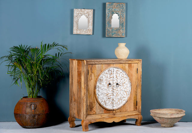 Side angle image of a carved wood furniture cabinet made from mango wood with floral detailing and whitewashed finish, 90 × 90 × 40 cm.