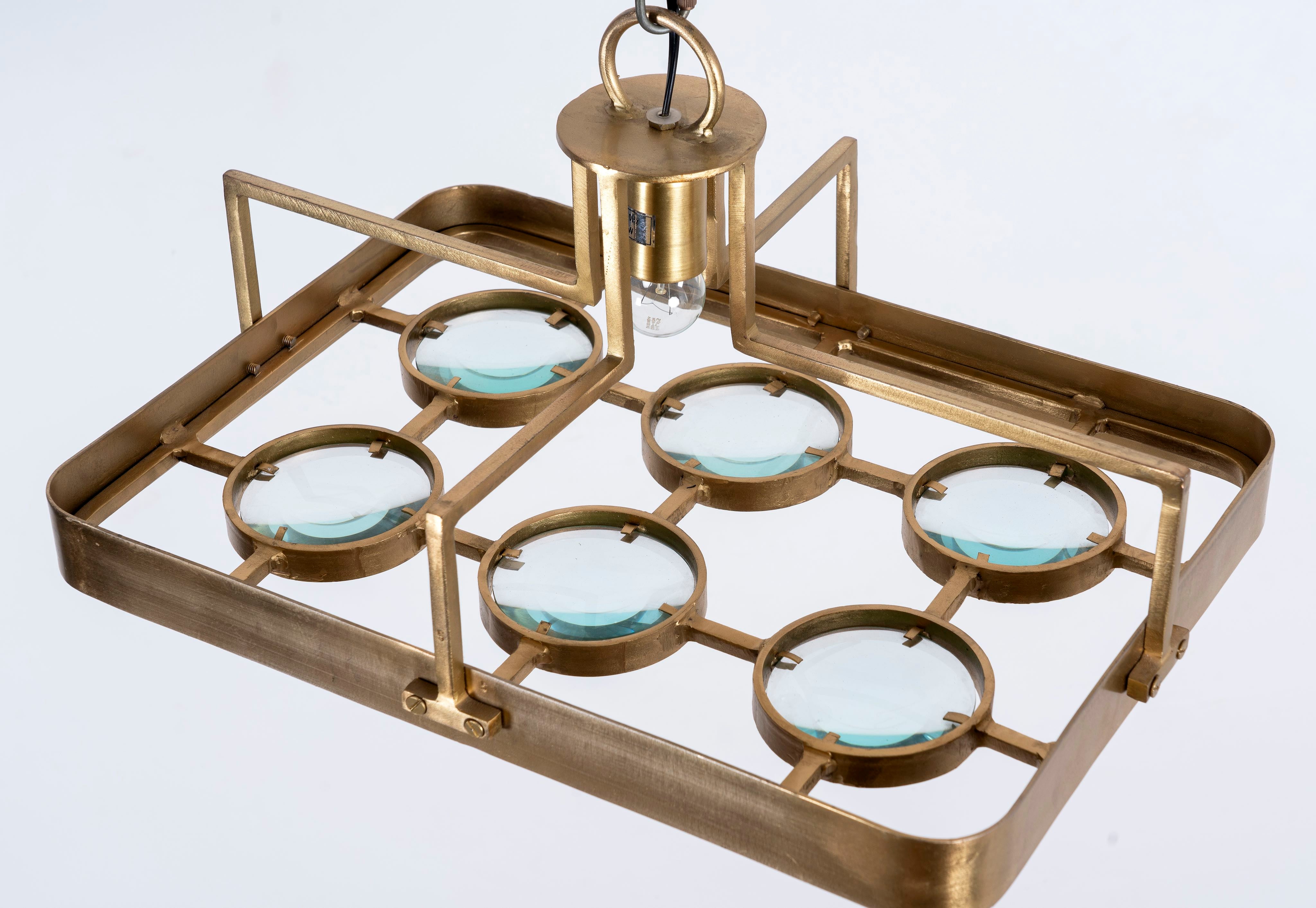 Unique pendant light with brass-plated iron square frame and magnifying blue and white glass inserts – vintage lighting piece ideal for kitchens, living rooms, or entryways.