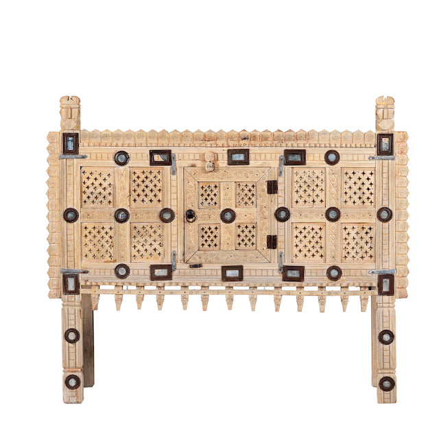 White background image of an sandblasted antique Indian teak chest with hand-carved details, original iron fittings, and a naturally aged finish, ideal for bohemian or vintage-inspired interiors.