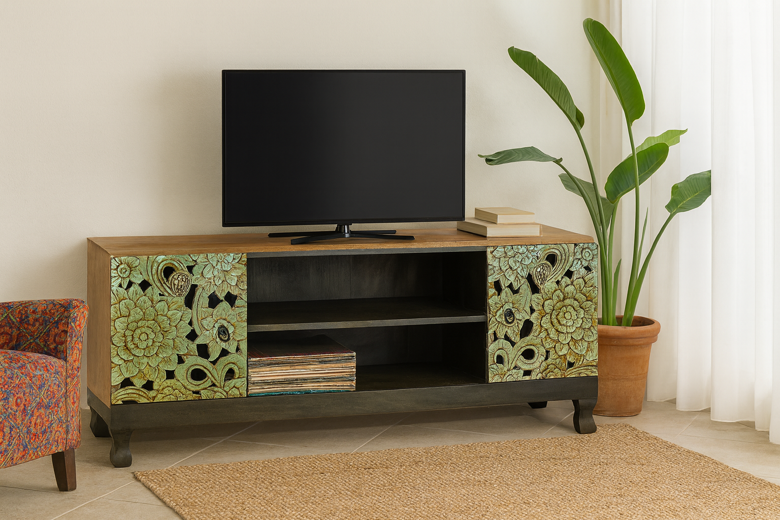 Lifestyle imagination of a carved mango wood lowboard with green floral doors, black frame, and open shelving, 150 × 60 × 40 cm.