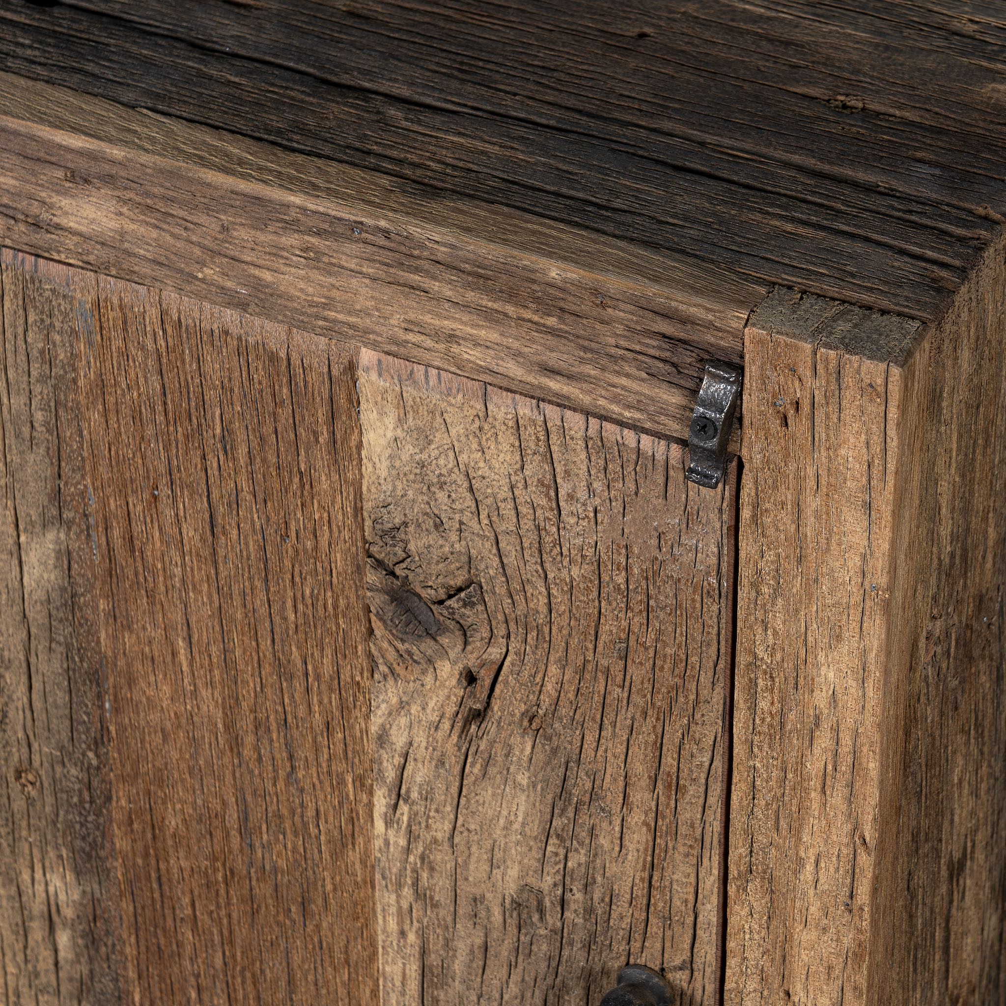 Close up view of a reclaimed wood bedside table with single cabinet door – handcrafted driftwood furniture ideal for rustic minimalism and natural interior styling.
