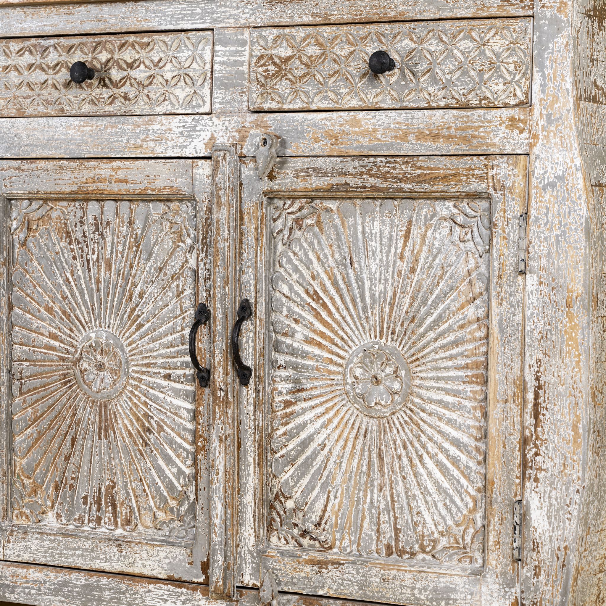 Close up picture view of a hand carved Mango wood sideboard with floral design, 4 doors and 4 drawers in vintage distressed look.