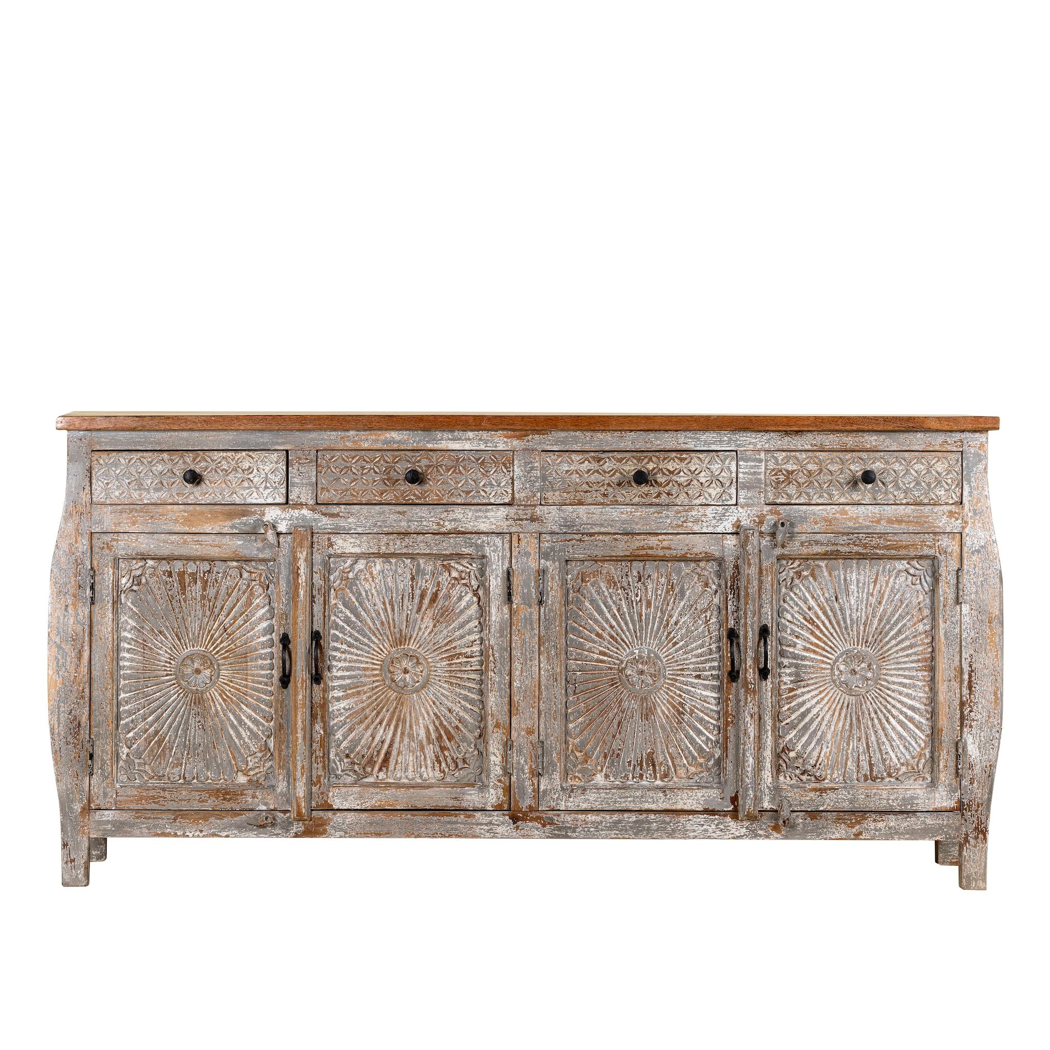 White background view of a hand carved Mango wood sideboard with floral design, 4 doors and 4 drawers in vintage distressed look.